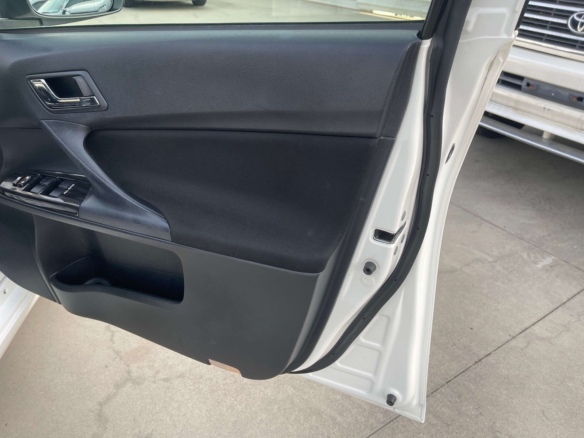 Interior door panel of a 2011 Toyota Mark X V6 3.5L 350S Sport Sedan showcasing modern design and features.