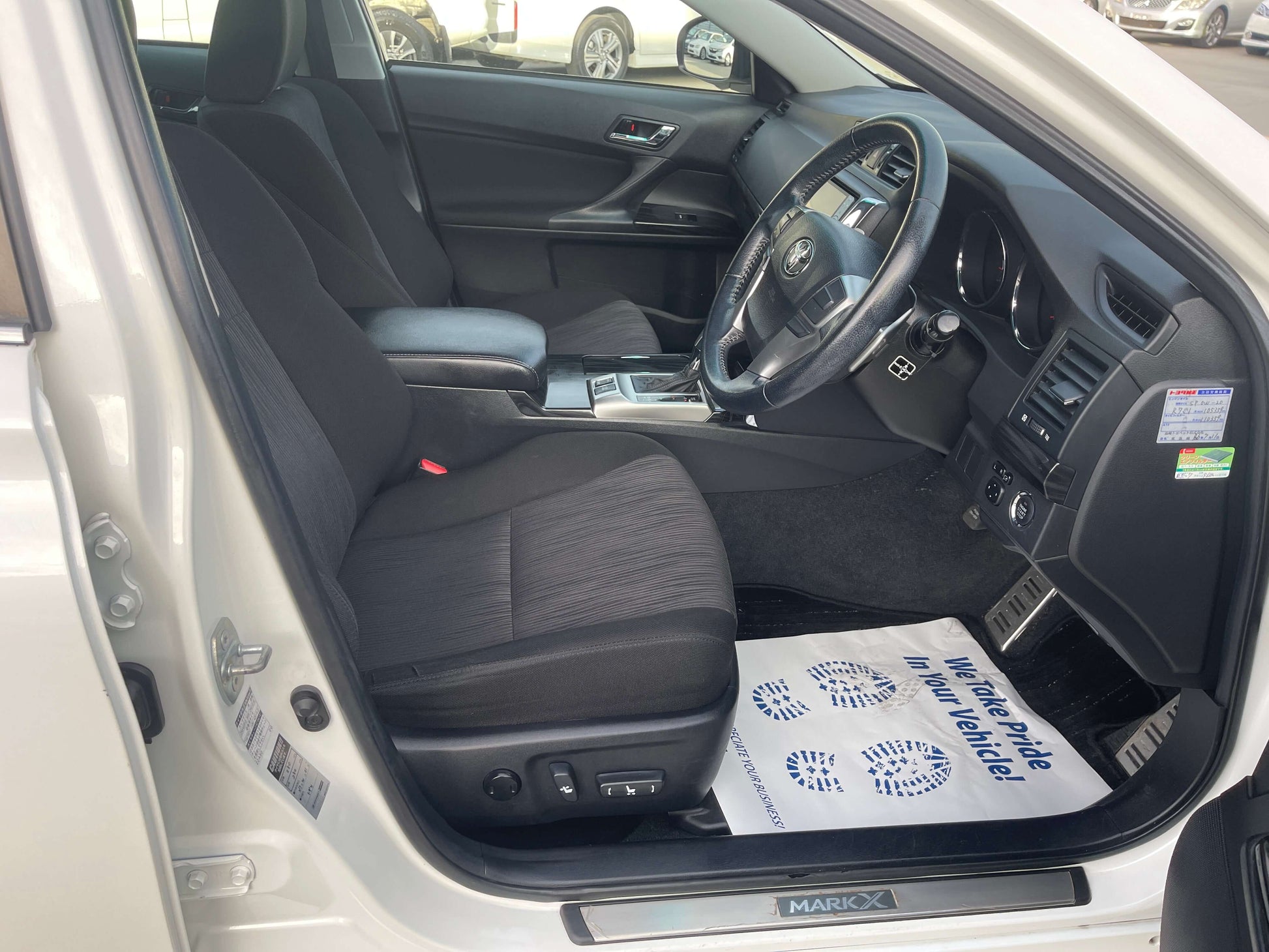 Interior view of 2011 Toyota Mark X V6 3.5L 350S Sport Sedan showcasing luxury seating and dashboard features.