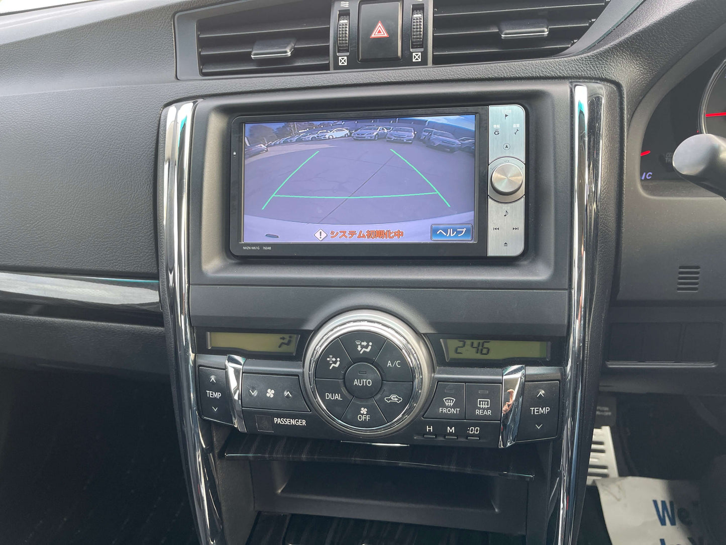 Interior view of a 2011 Toyota Mark X showing the multi-function display and rear-view camera system.