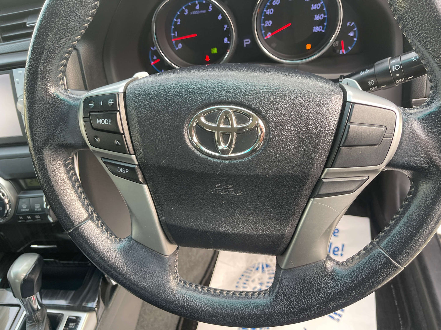 Interior view of the steering wheel of a 2011 Toyota Mark X V6 3.5L 350S Sport Sedan with controls.