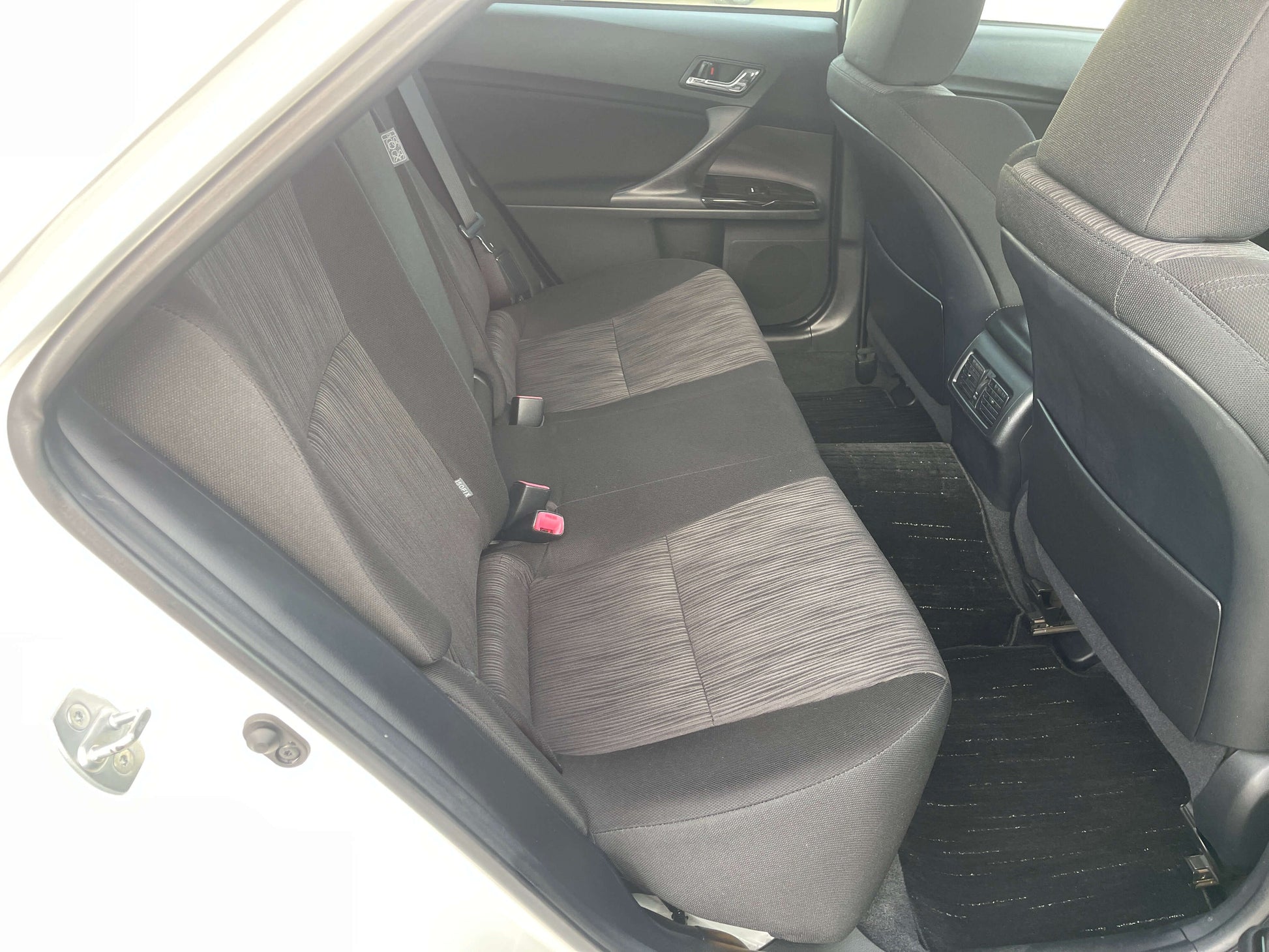 Interior view of the rear seat of a 2011 Toyota Mark X V6 3.5L 350S Sport Sedan showing comfortable seating.