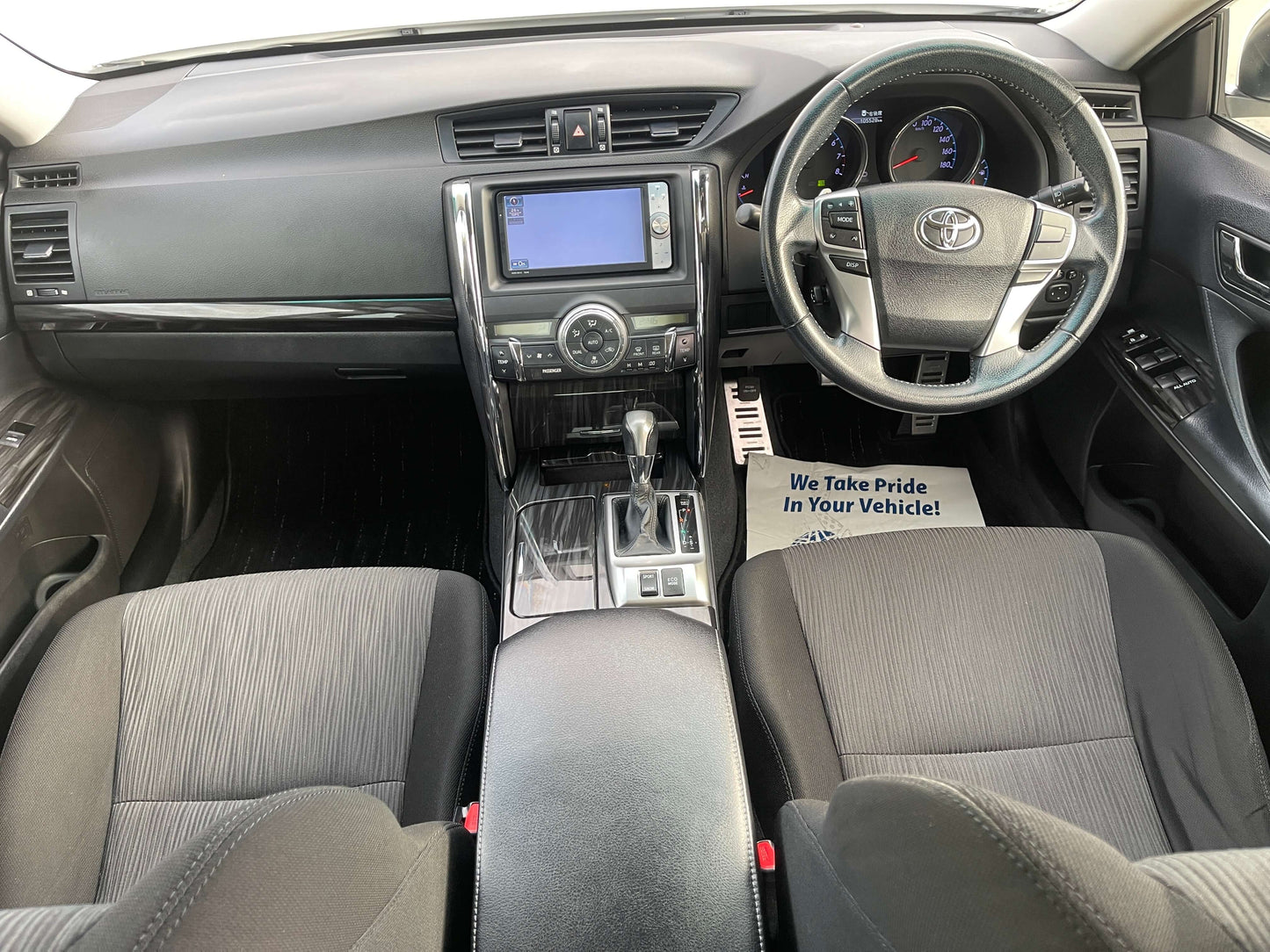 Interior view of 2011 Toyota Mark X V6 3.5L 350S Sport Sedan showcasing dashboard, steering wheel, and seating.