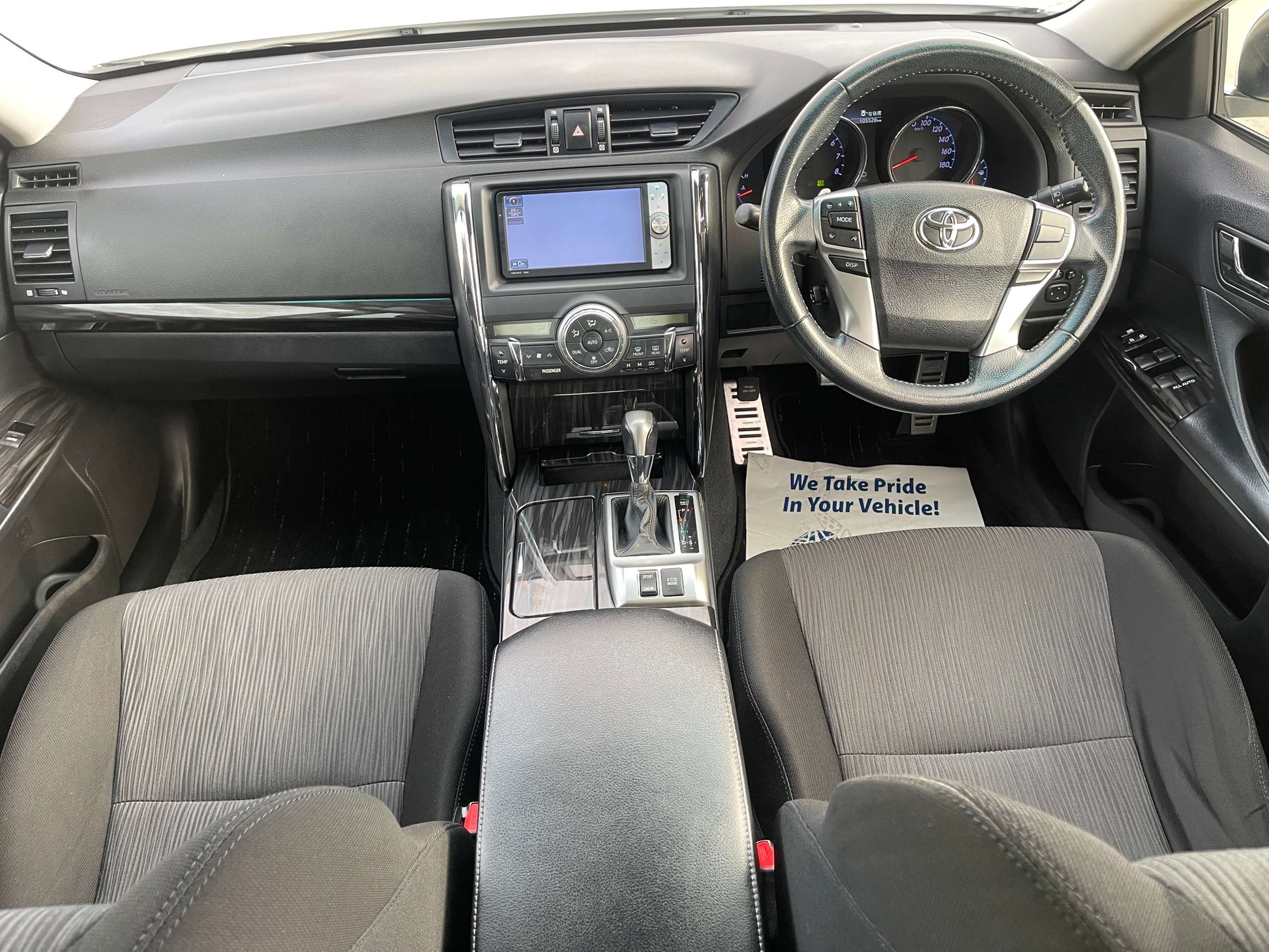 Interior view of 2011 Toyota Mark X V6 3.5L 350S Sport Sedan showcasing dashboard, steering wheel, and seating.