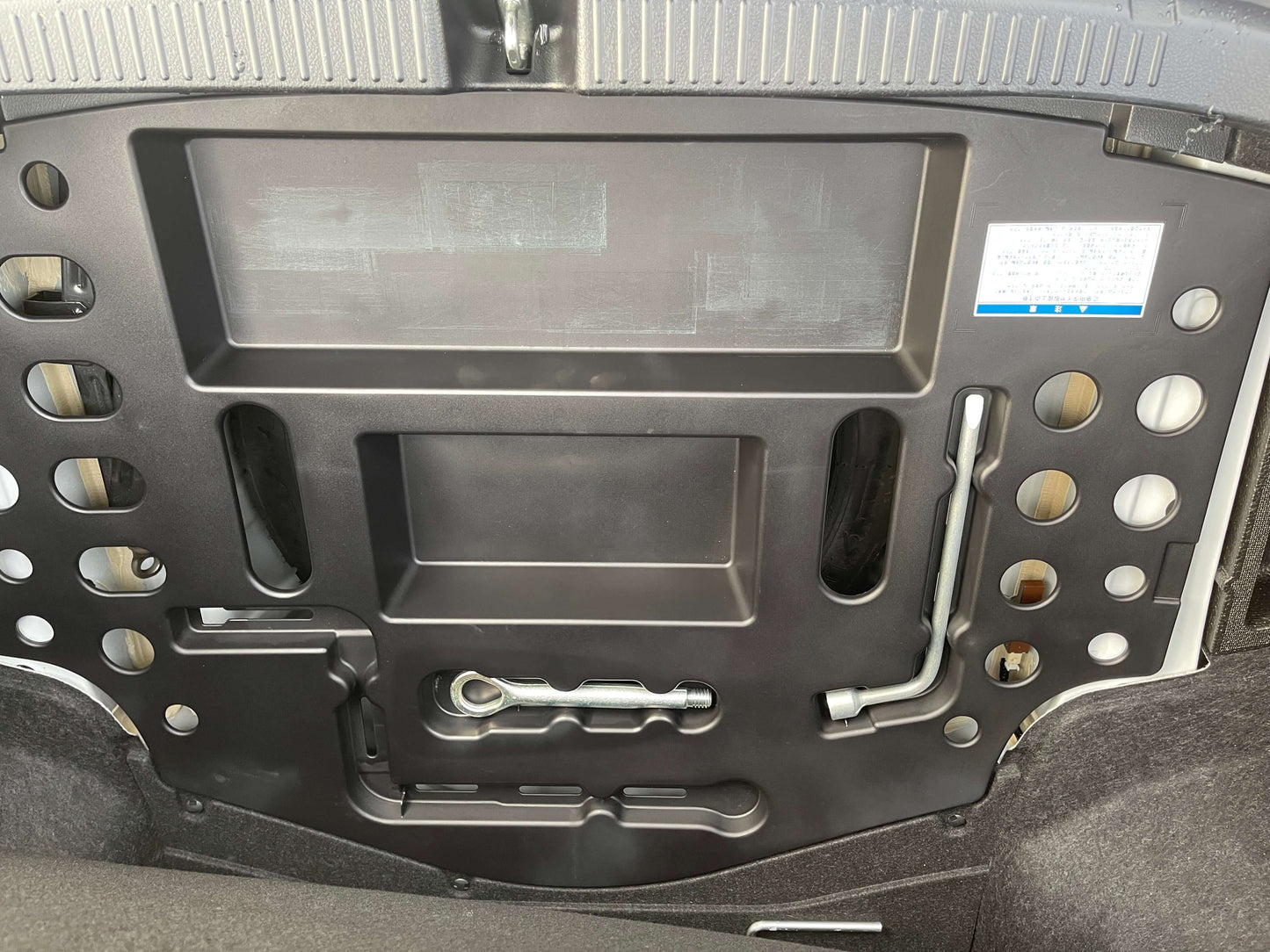 Interior view of the trunk lid of a 2011 Toyota Mark X showing structural design and components.