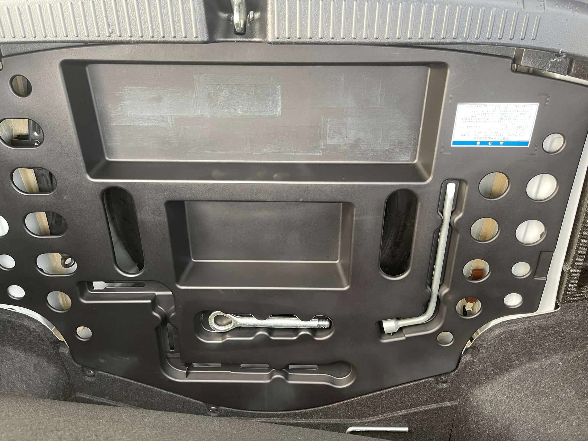 Interior view of the trunk lid of a 2011 Toyota Mark X showing structural design and components.
