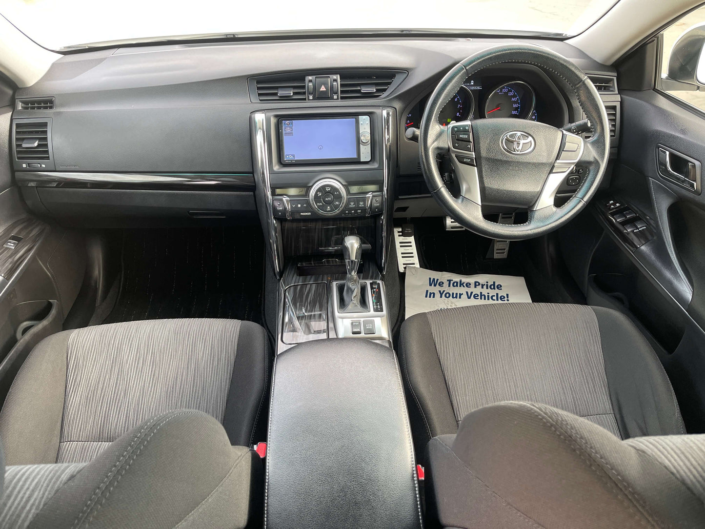 Interior view of 2011 Toyota Mark X V6 3.5L 350S Sport Sedan showcasing modern dashboard and seats.