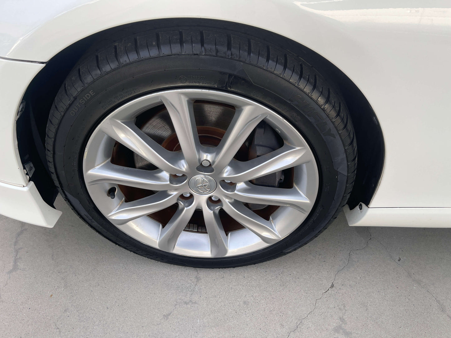 Close-up of 2011 Toyota Mark X V6 3.5L 350S Sport Sedan wheel and tire showcasing stylish alloy rims.