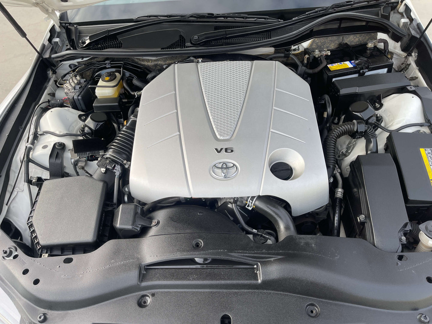 Engine compartment of 2011 Toyota Mark X V6, showcasing the powerful 3.5L V6 engine.