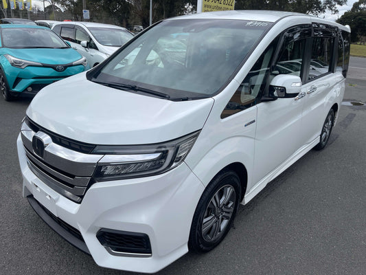 2018 Honda Honda Stepwgn 2.0 Spada Hybrid G Honda Sensing white MPV parked in a dealership with modern design.