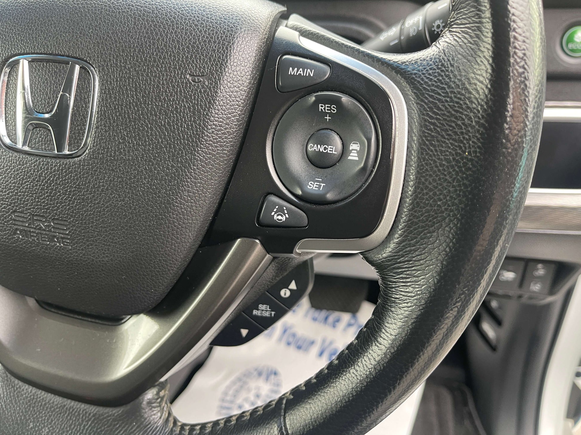 Steering wheel controls of 2018 Honda Honda Stepwgn 2.0 Spada Hybrid G Honda Sensing with buttons for main and cruise functions.