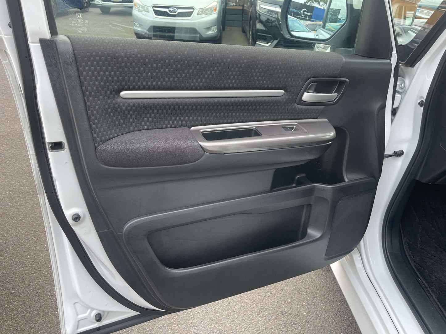 Interior door panel of 2018 Honda Honda Stepwgn 2.0 Spada Hybrid G Honda Sensing showing sleek design and materials