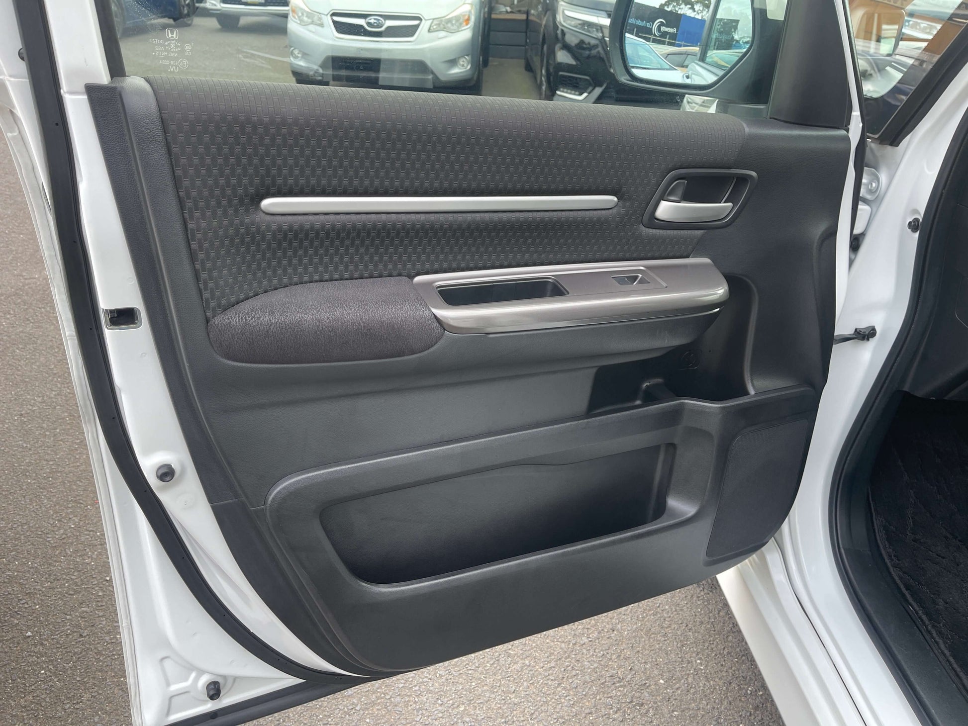 Interior door panel of 2018 Honda Honda Stepwgn 2.0 Spada Hybrid G Honda Sensing showing sleek design and materials