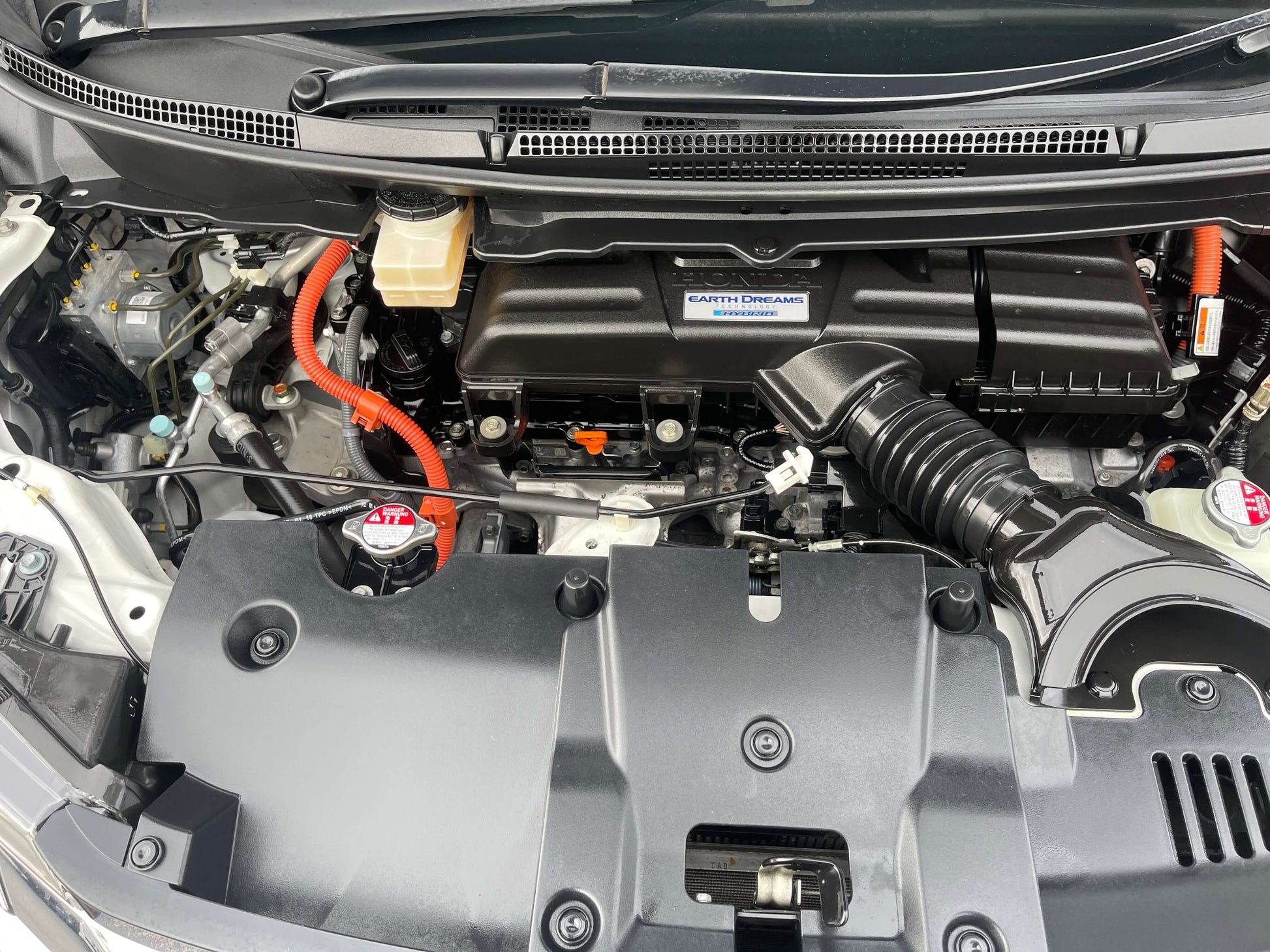 Engine compartment of 2018 Honda Honda Stepwgn 2.0 Spada Hybrid G Honda Sensing showcasing hybrid components.