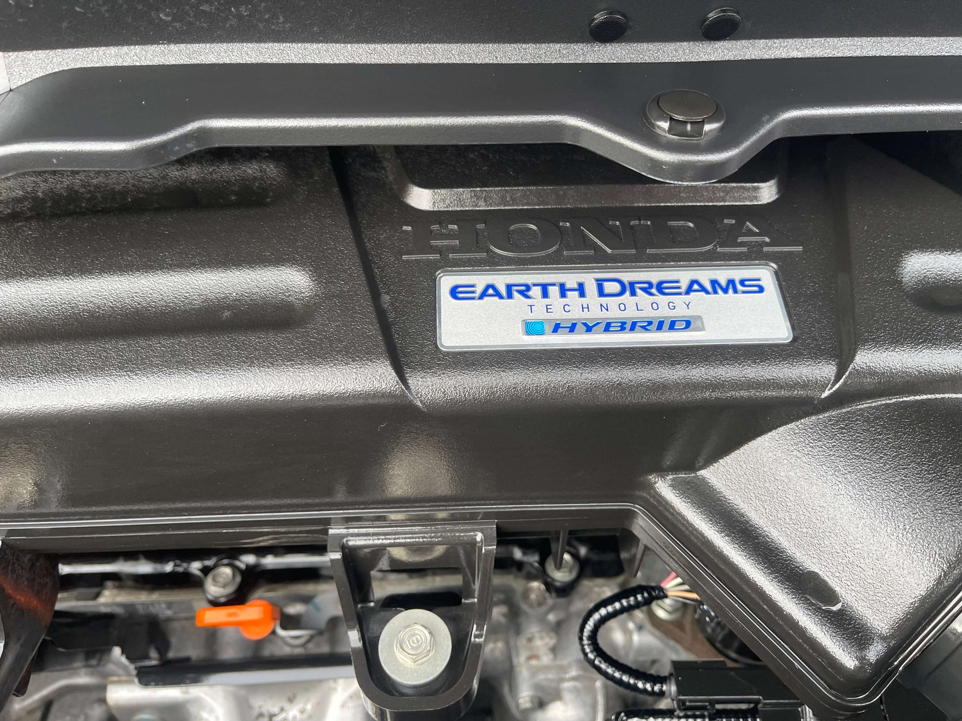 Image of the Honda Earth Dreams Technology emblem on a hybrid engine, showcasing efficiency and innovation in the 2018 Honda Honda Stepwgn 2.0 Spada Hybrid G Honda Sensing.