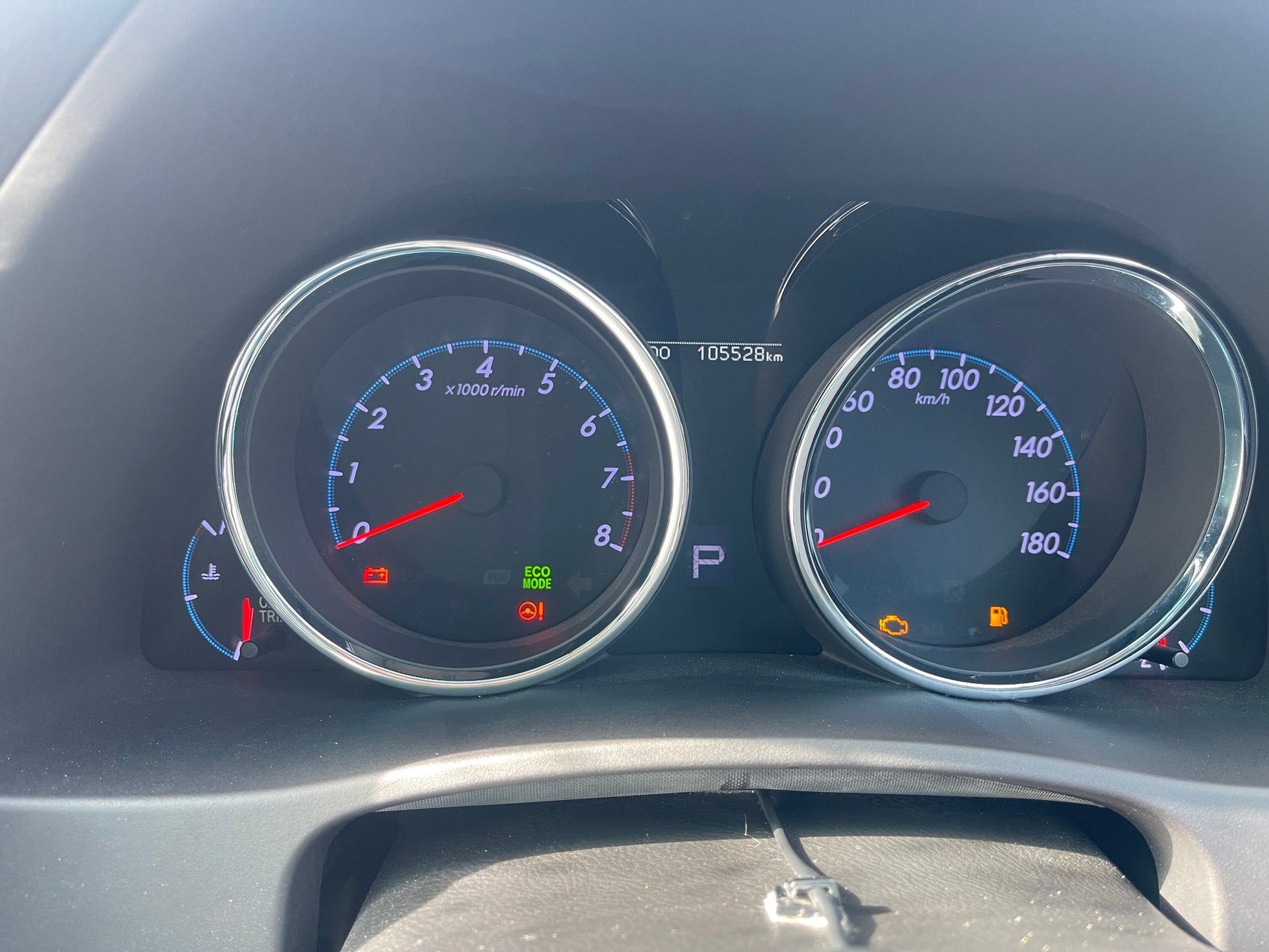 Dashboard of 2011 Toyota Mark X showing speedometer, tachometer, and warning lights with 105,528 km on odometer.