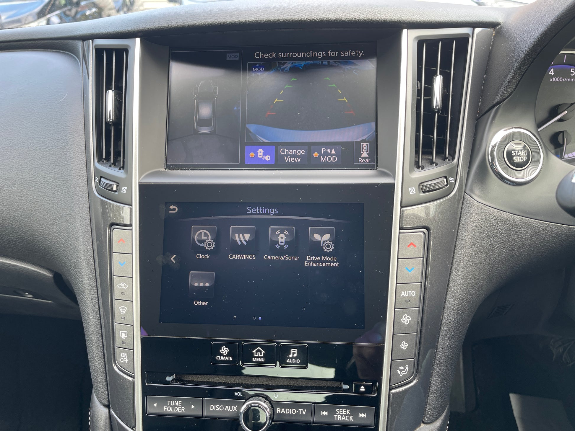 Interior dashboard of 2016 Nissan Skyline V6 3.5L Hybrid showing infotainment display and settings menu.