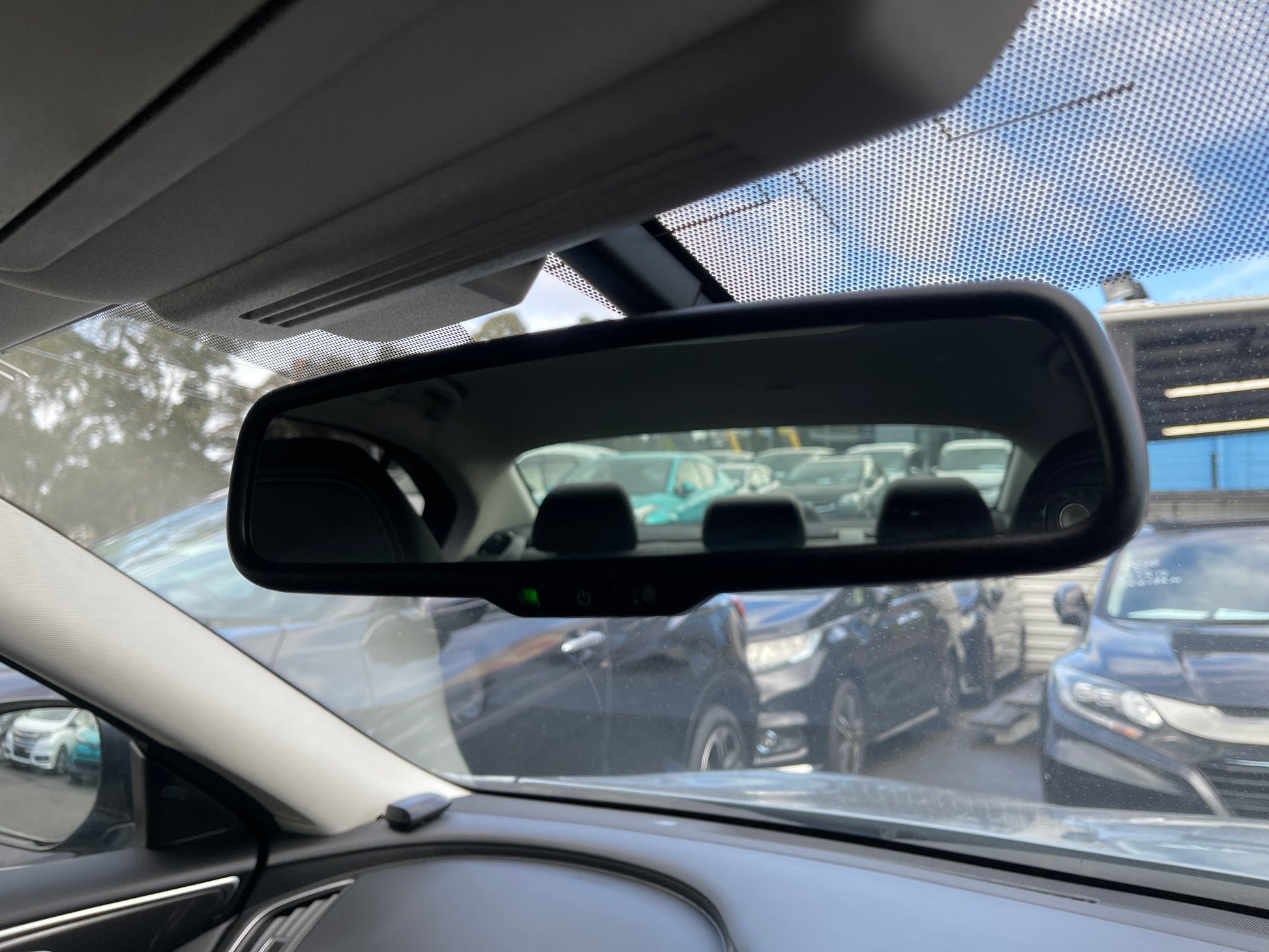 Rearview mirror of a 2016 Nissan Skyline V6 3.5L Hybrid 350GT showing vehicle interiors and background cars.