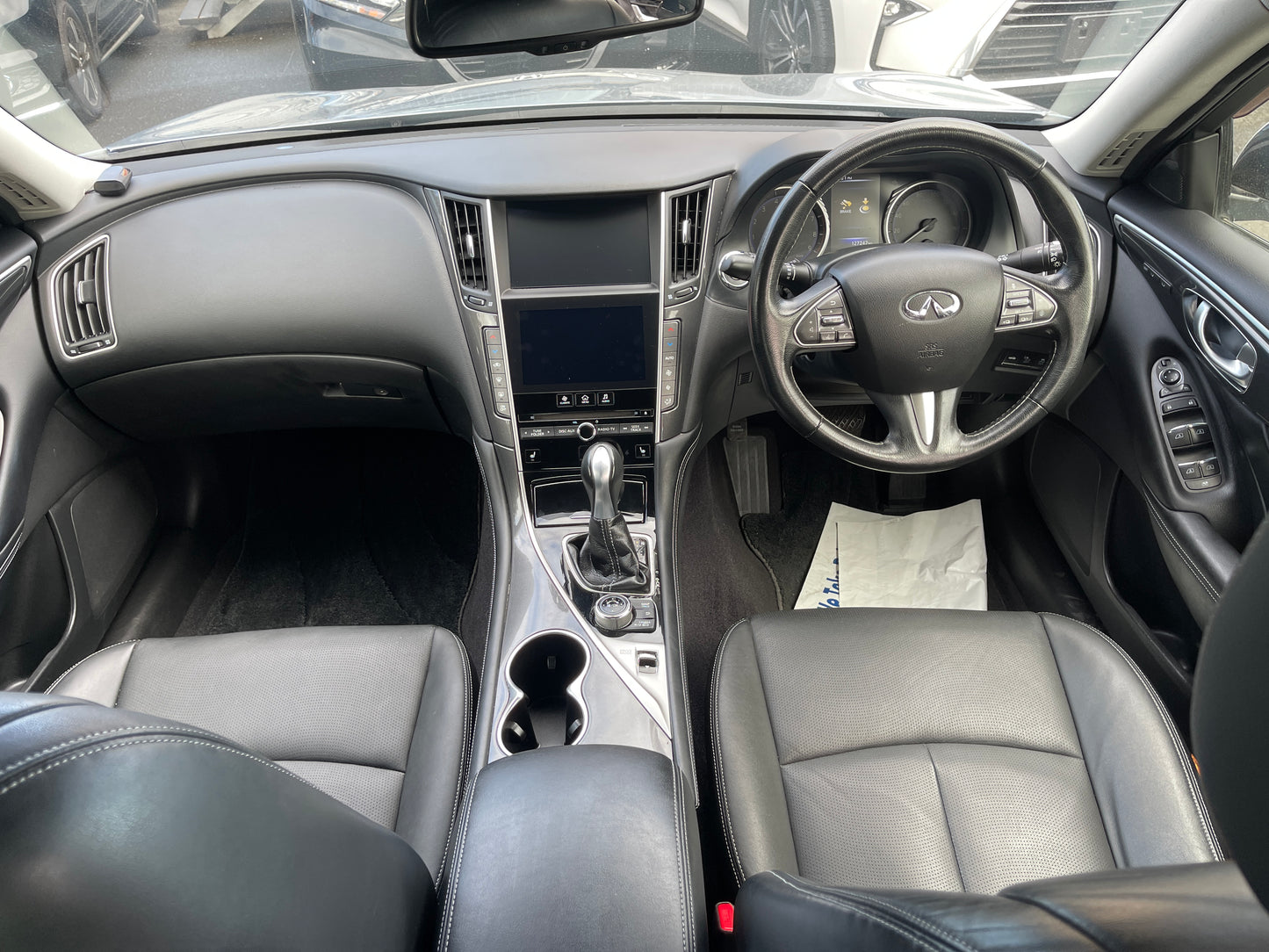 Interior view of a 2016 Nissan Skyline V6 3.5L Hybrid 350GT showing leather seats and dashboard.