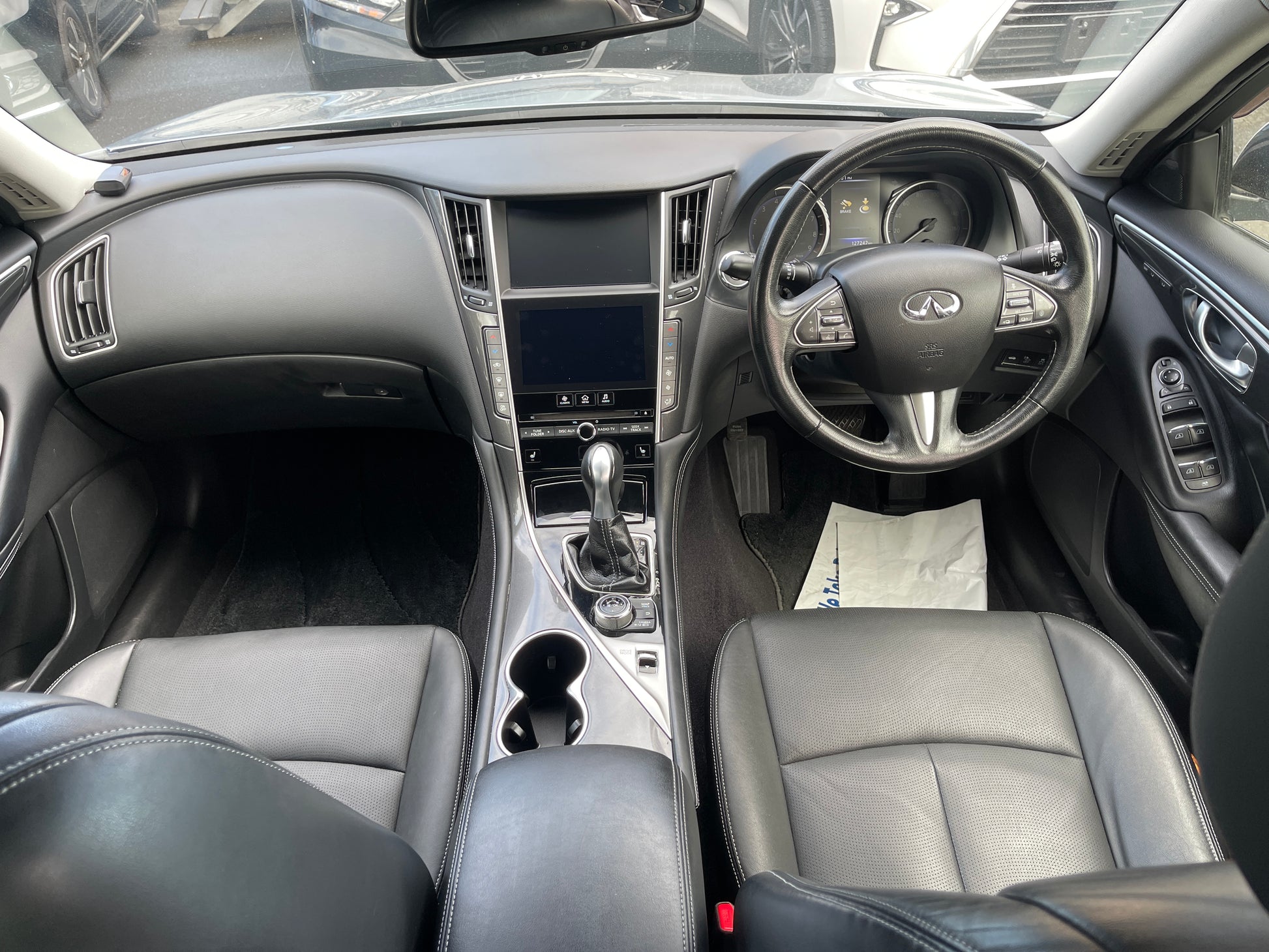 Interior view of a 2016 Nissan Skyline V6 3.5L Hybrid 350GT showing leather seats and dashboard.