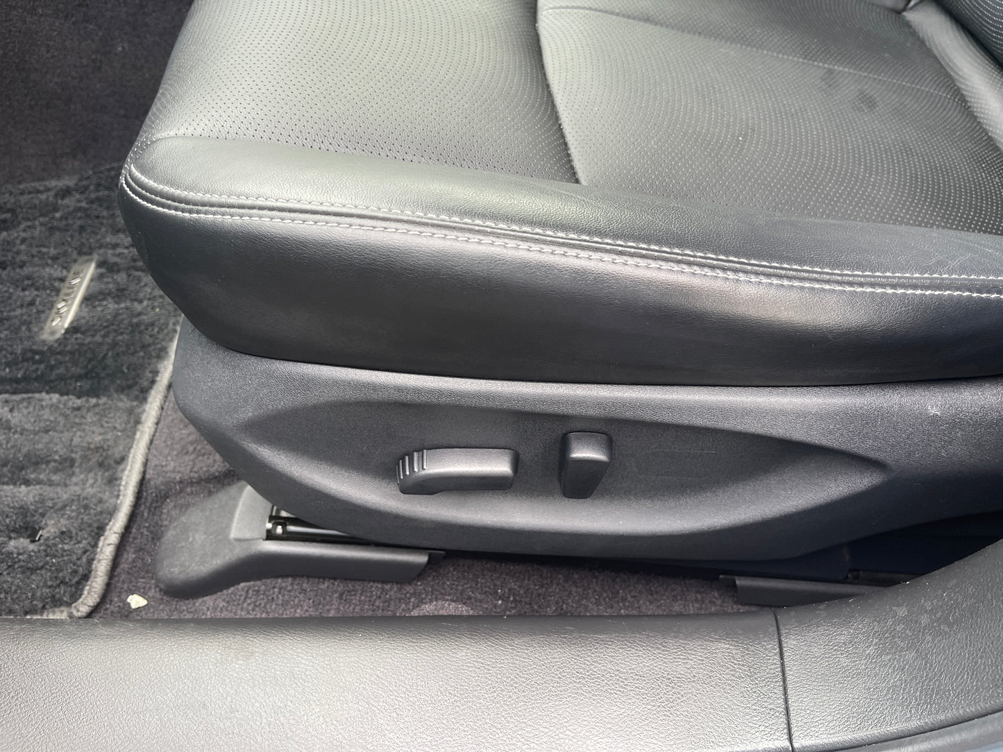 2016 Nissan Skyline V6 3.5L Hybrid front driver seat adjustment controls in black leather interior