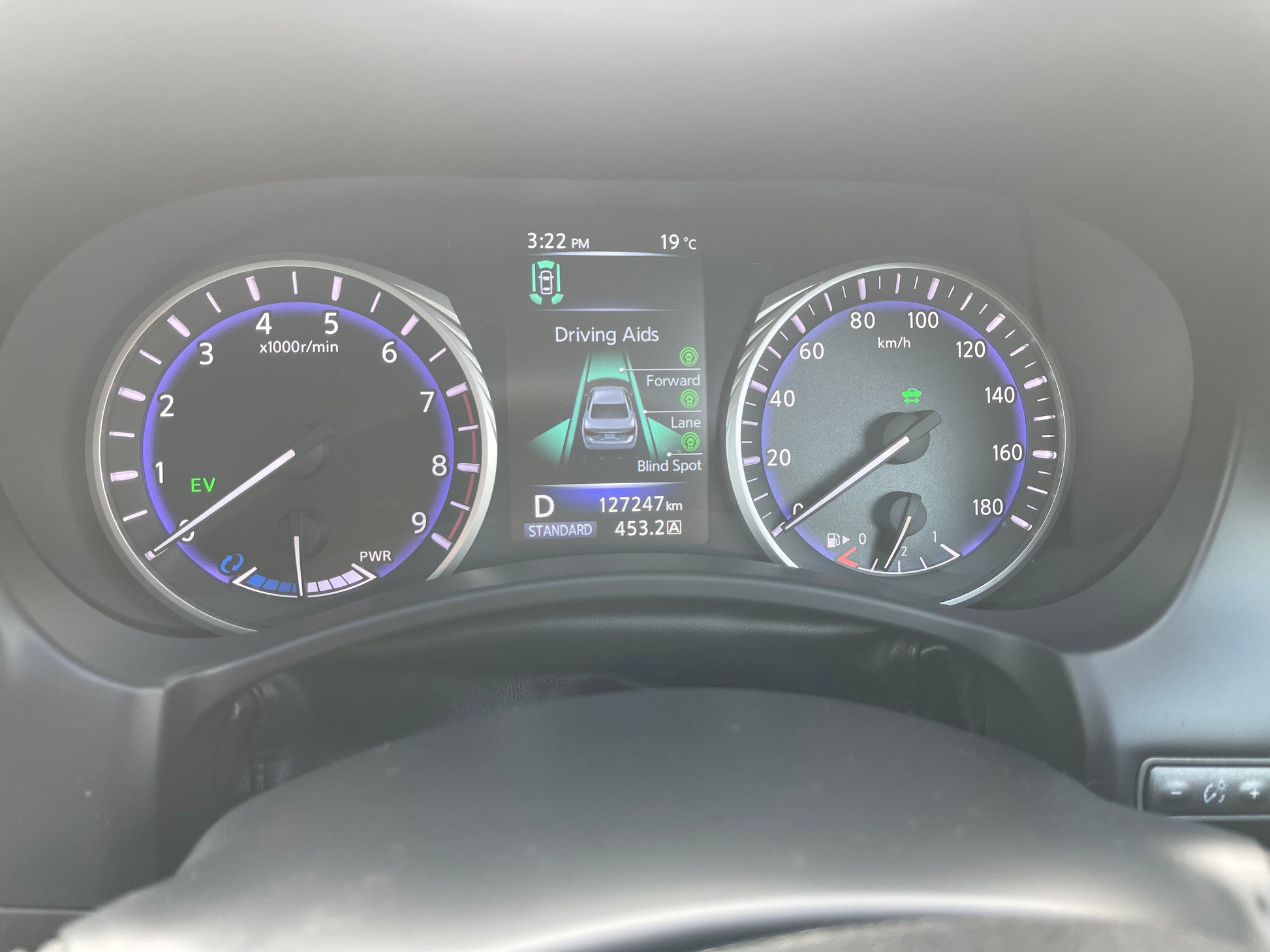 2016 Nissan Skyline V6 3.5L Hybrid dashboard display, showing speedometer and driving aids features.