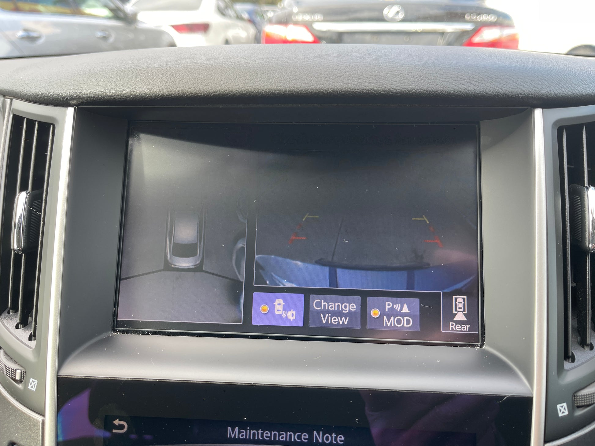 Interior display of the 2016 Nissan Skyline V6 3.5L Hybrid showing rear view camera features and maintenance note.