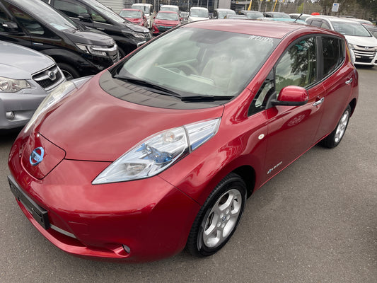 2013 Nissan Leaf 24kW G-Edition Full Electric in red color parked among other cars.