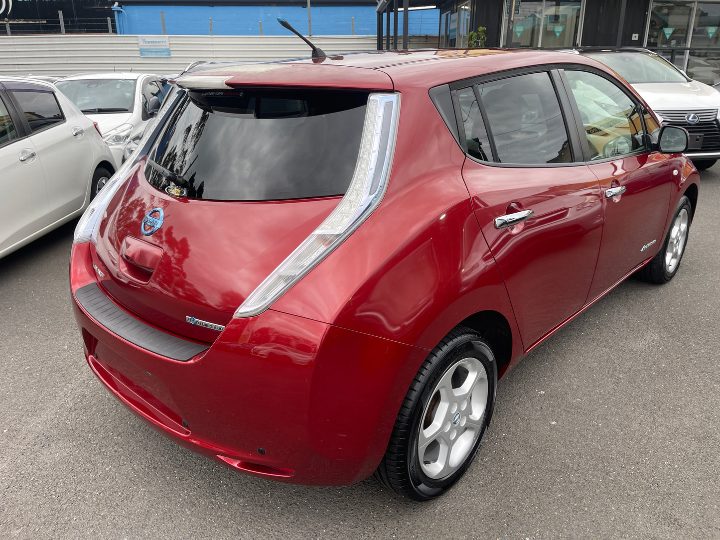 2013 Nissan Leaf 24kW G-Edition Full Electric rear view parked with other cars in the background.