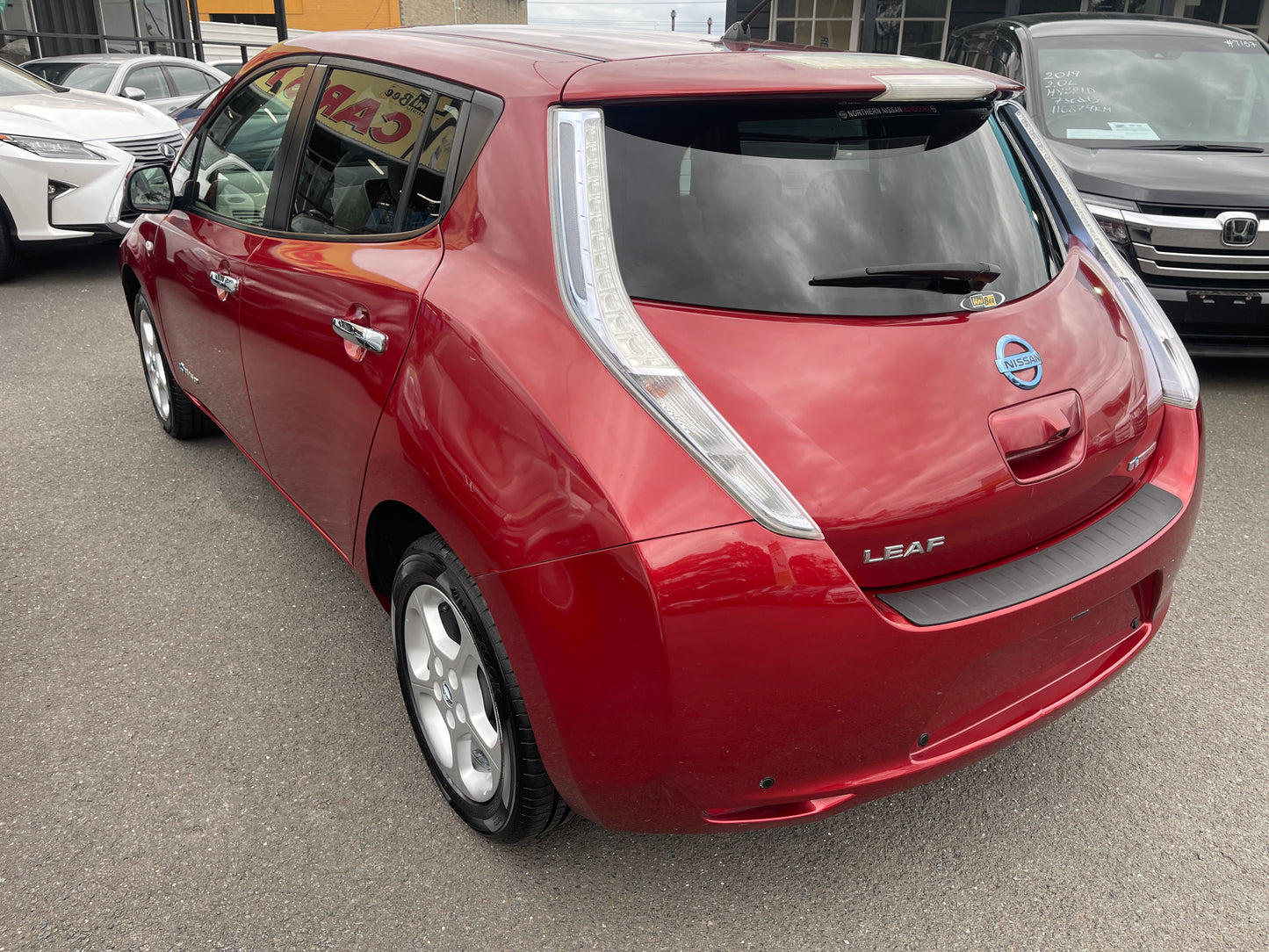 2013 Nissan Leaf 24kW G-Edition Full Electric rear view, red color, showcasing features and design.