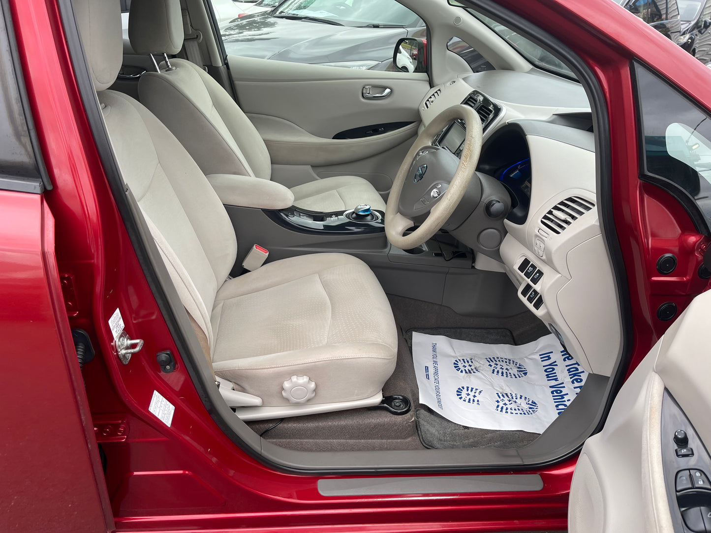 Interior view of 2013 Nissan Leaf 24kW G-Edition Full Electric showcasing seats and dashboard.