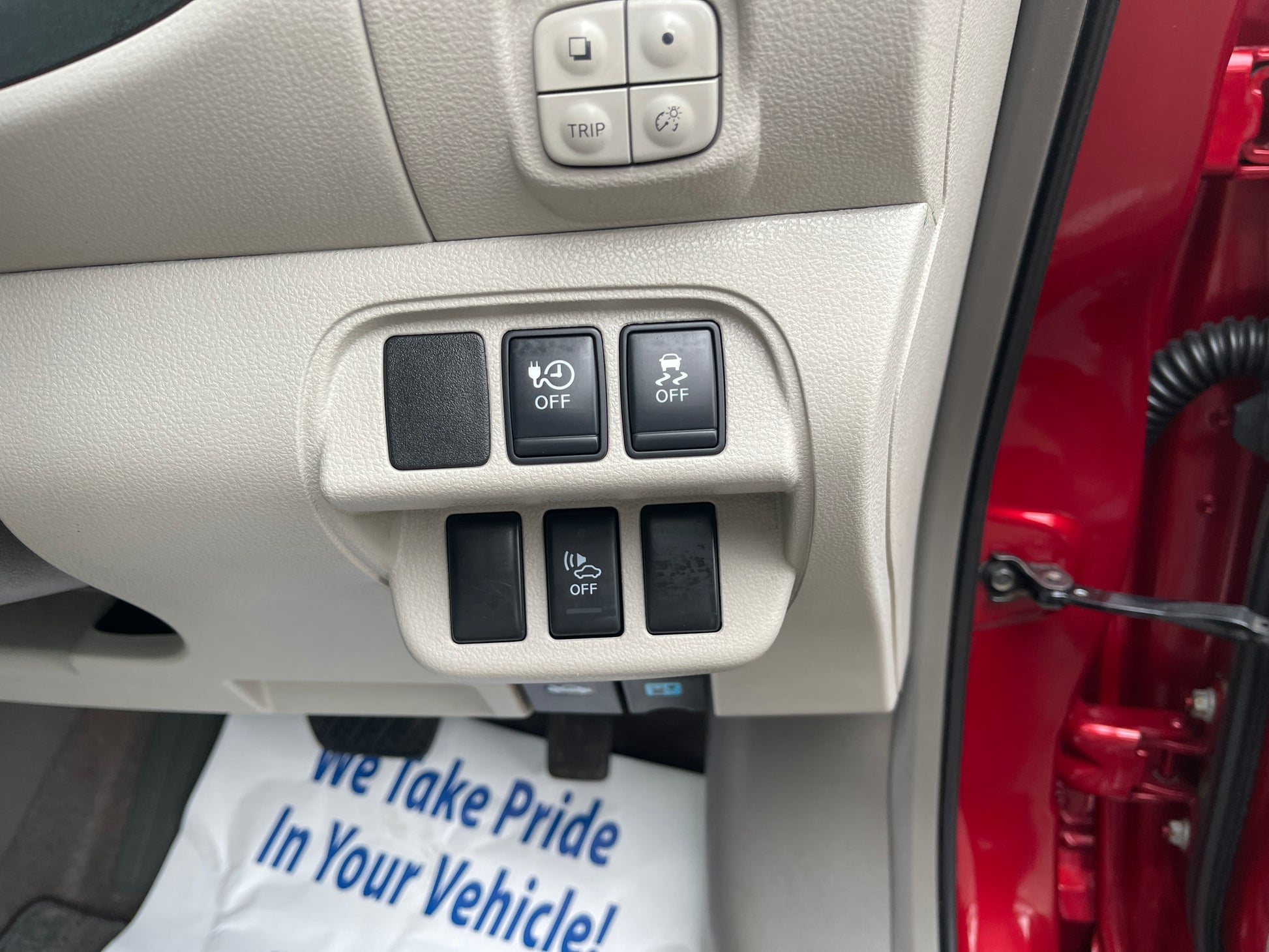 Control panel of a 2013 Nissan Leaf 24kW G-Edition Full Electric with various buttons for vehicle settings.