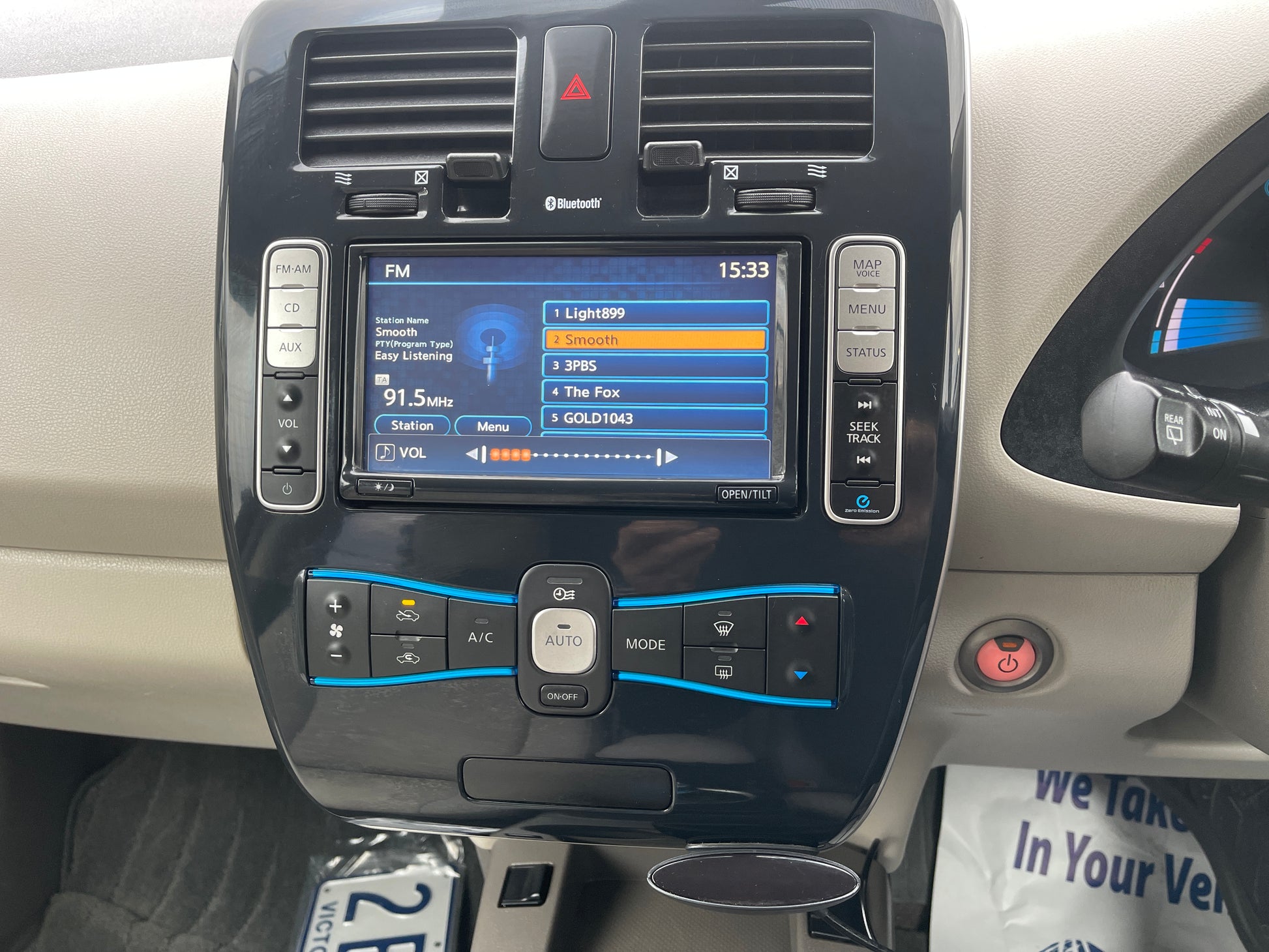 Interior dashboard of a 2013 Nissan Leaf 24kW G-Edition Full Electric showing radio controls and display.