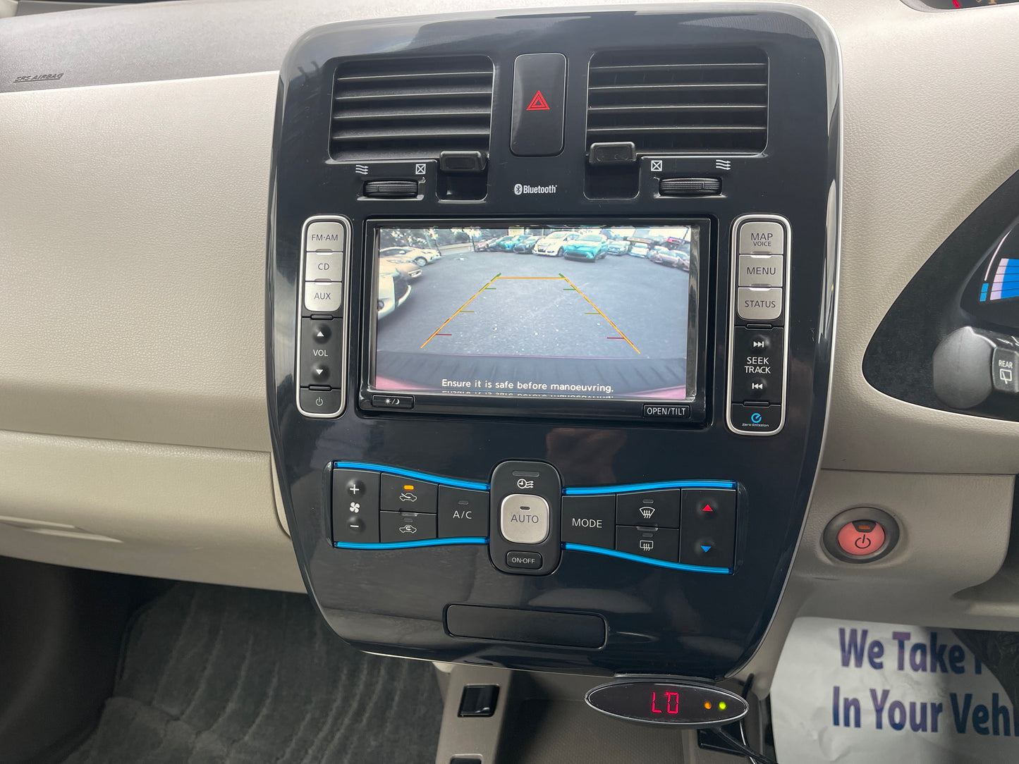 2013 Nissan Leaf 24kW G-Edition Full Electric dashboard display with reverse camera and controls.