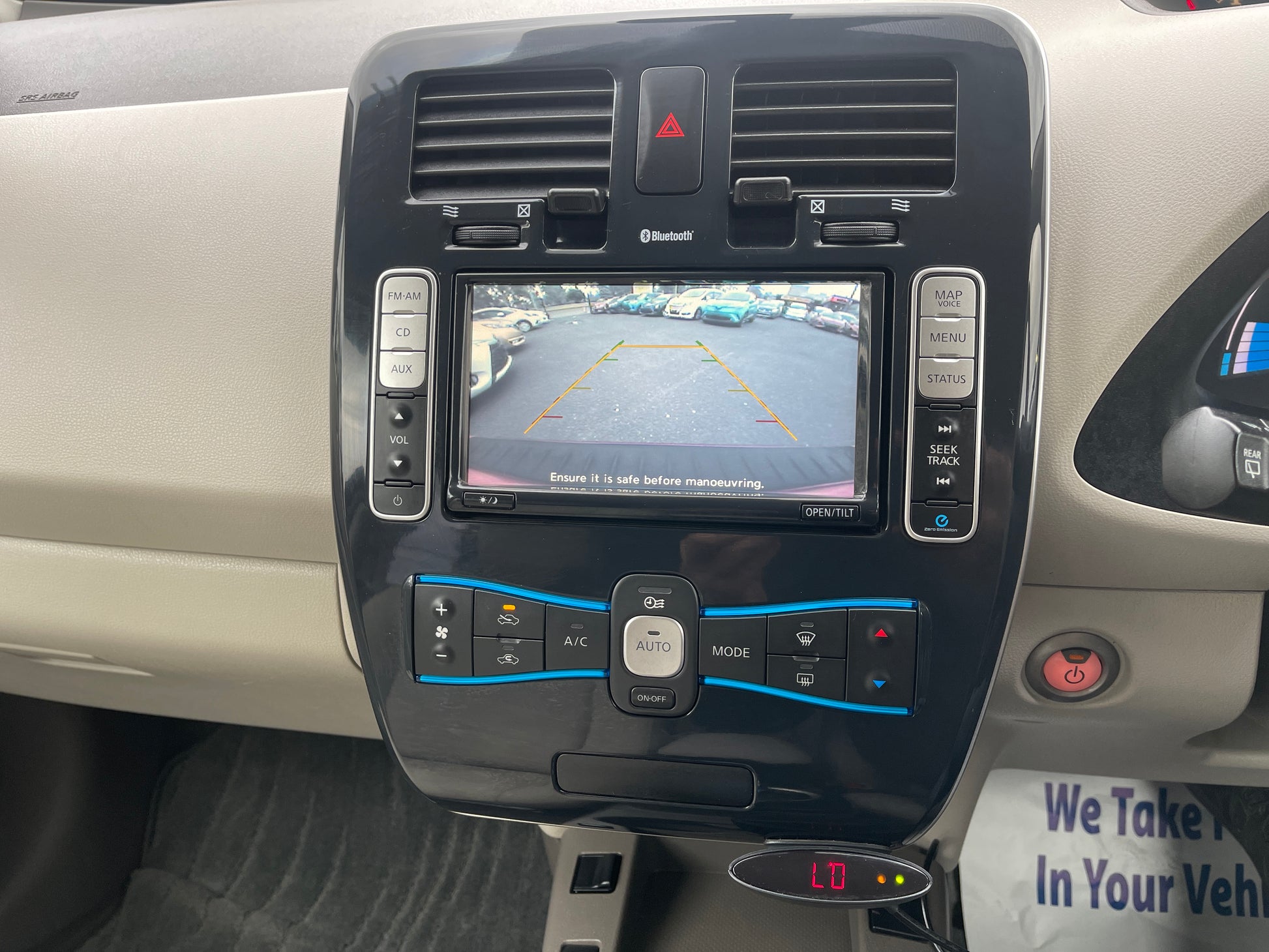 2013 Nissan Leaf 24kW G-Edition Full Electric dashboard display with reverse camera and controls.