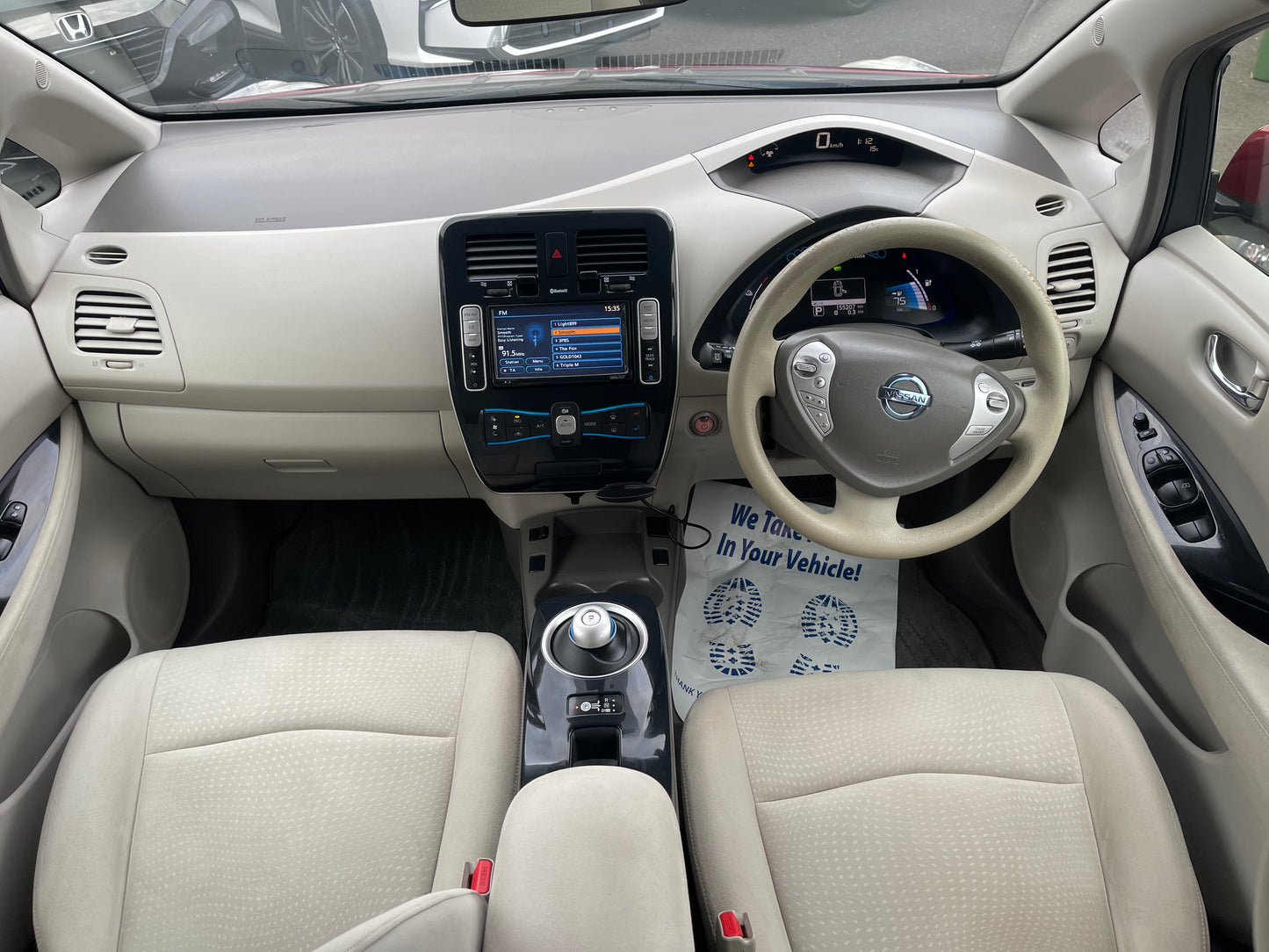 Interior view of a 2013 Nissan Leaf 24kW G-Edition Full Electric showing dashboard and seats.