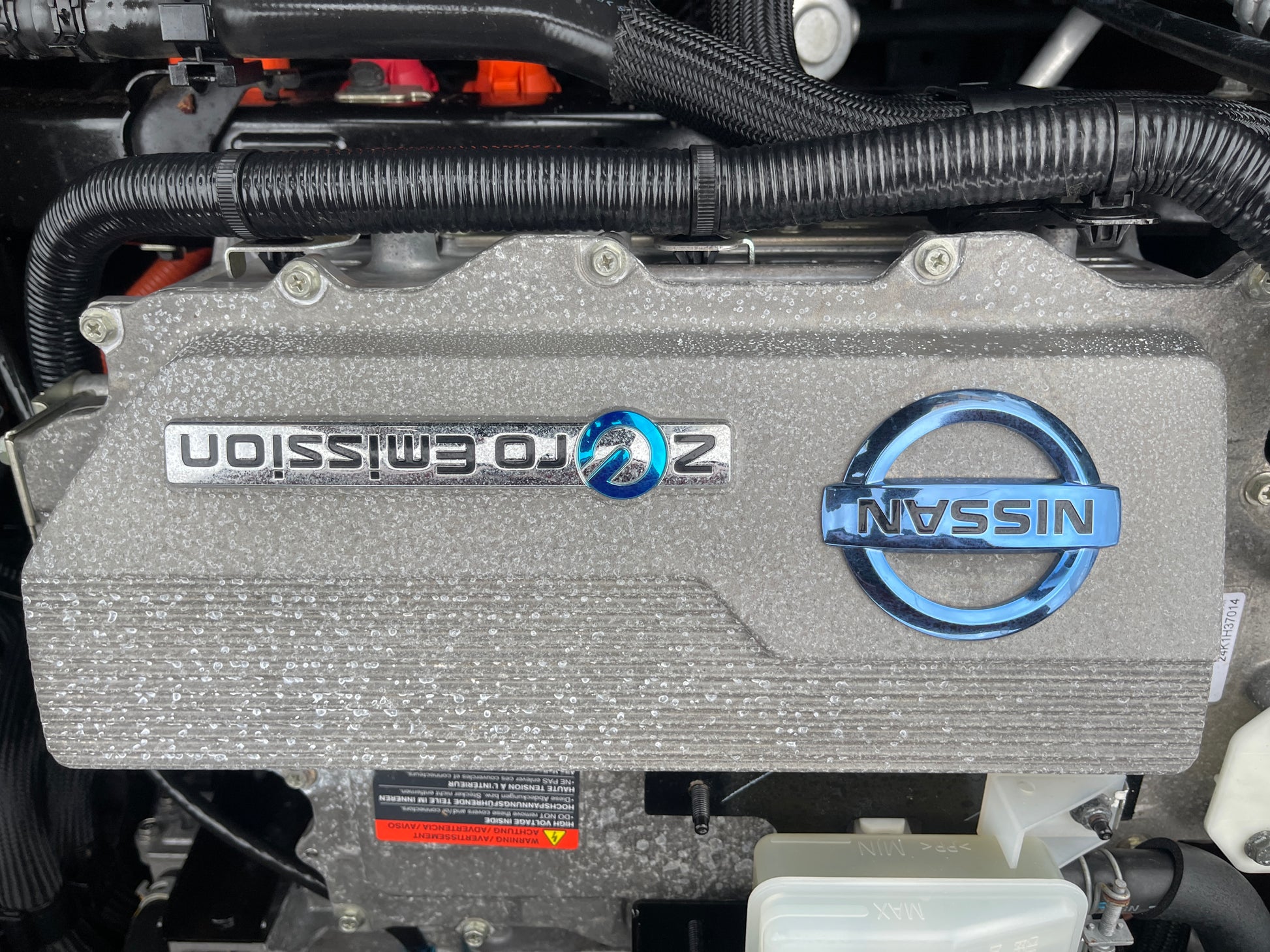 Engine cover of a 2013 Nissan Leaf 24kW G-Edition Full Electric with Nissan logo and Zero Emission badge.