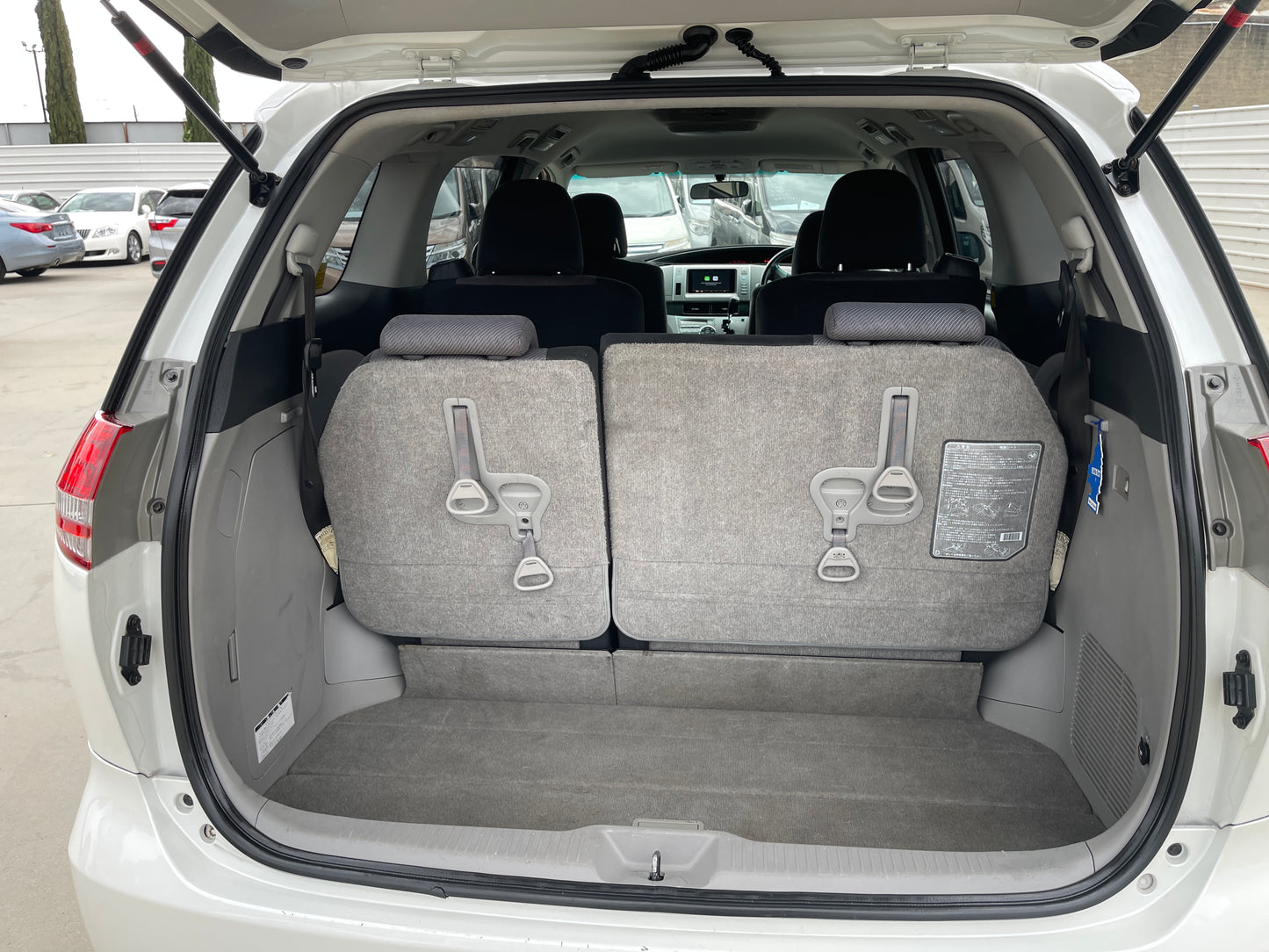 2006 Toyota Estima Aeras V6 3.5L interior view showing rear seats folded down for more cargo space.