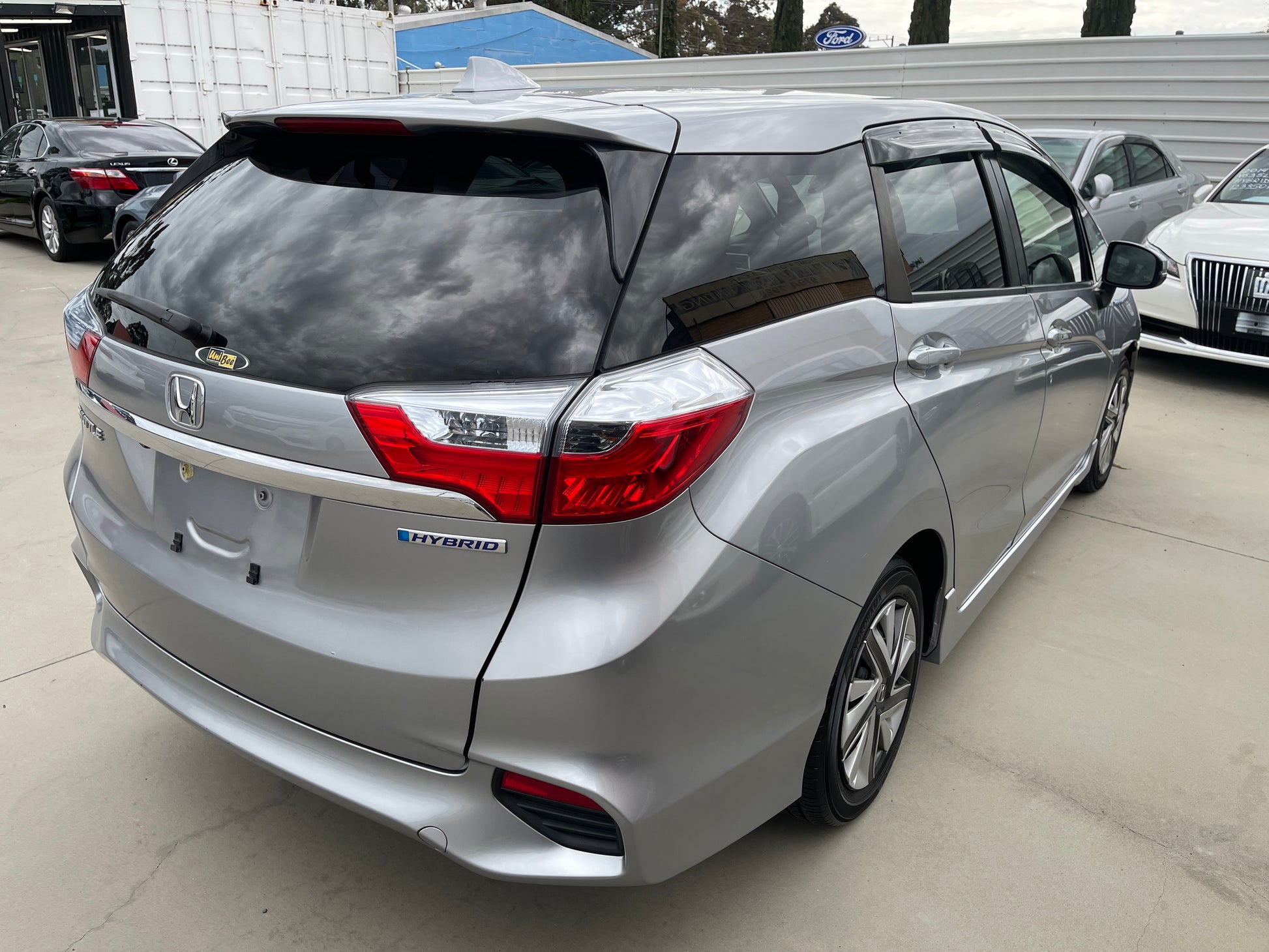2018 Honda Shuttle 1.5 Hybrid X Honda Sensing Edition, silver 5-seater hybrid vehicle, showcasing rear view.