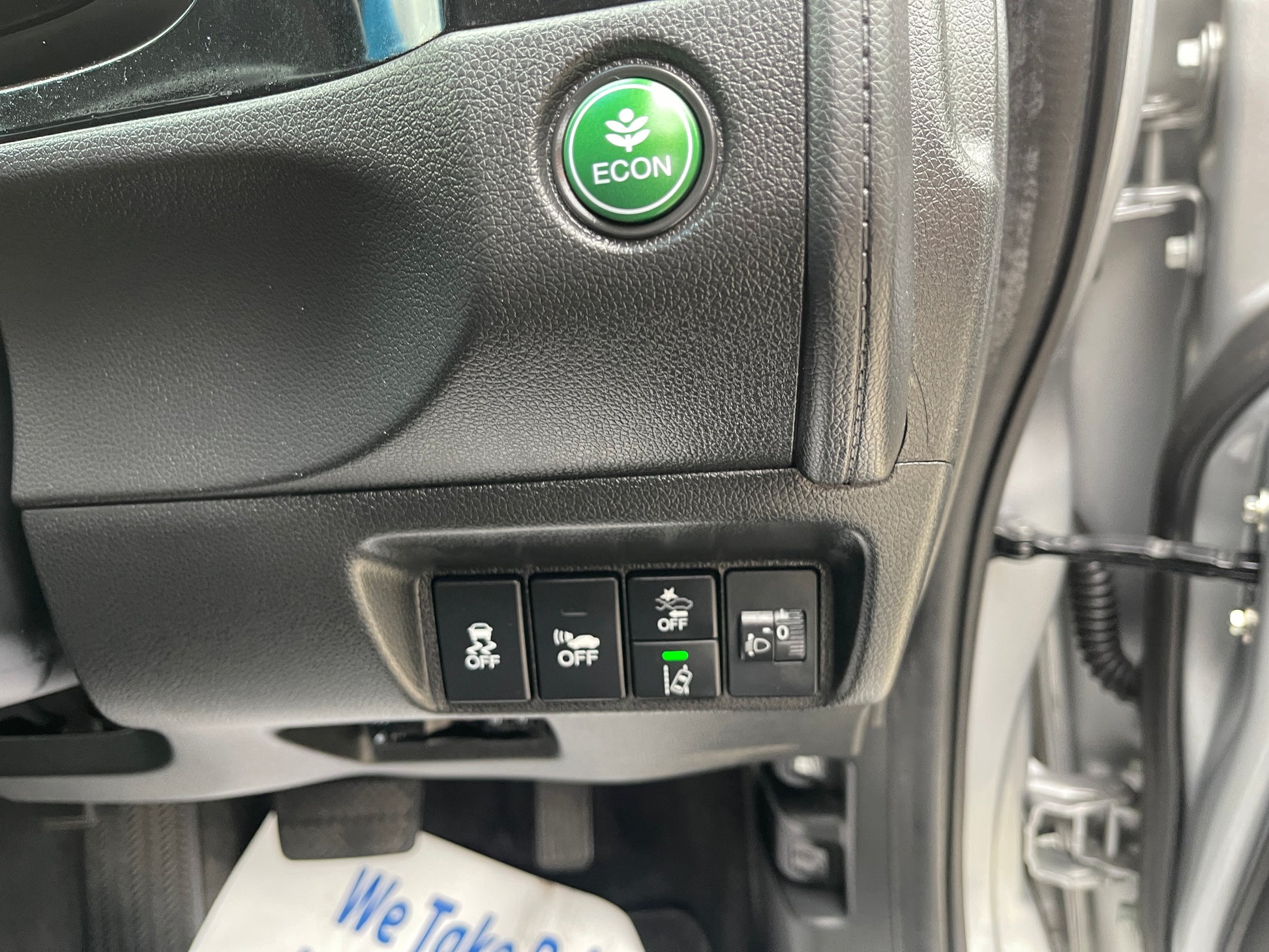 Close-up of controls in 2018 Honda Shuttle 1.5 Hybrid, featuring ECON button and various function switches.