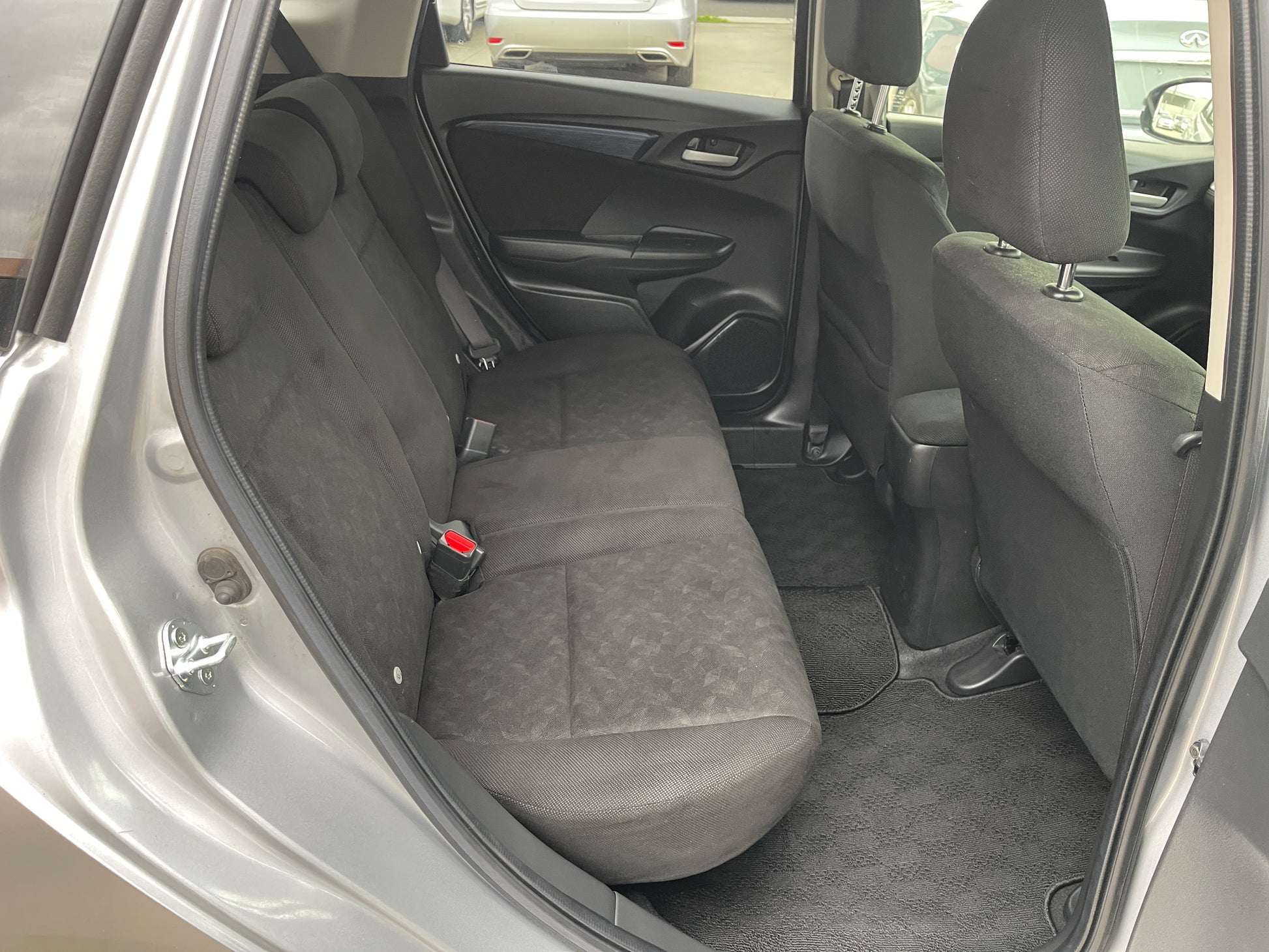 Interior view of the rear seating area in a 2018 Honda Shuttle 1.5 Hybrid, showcasing spacious seats.