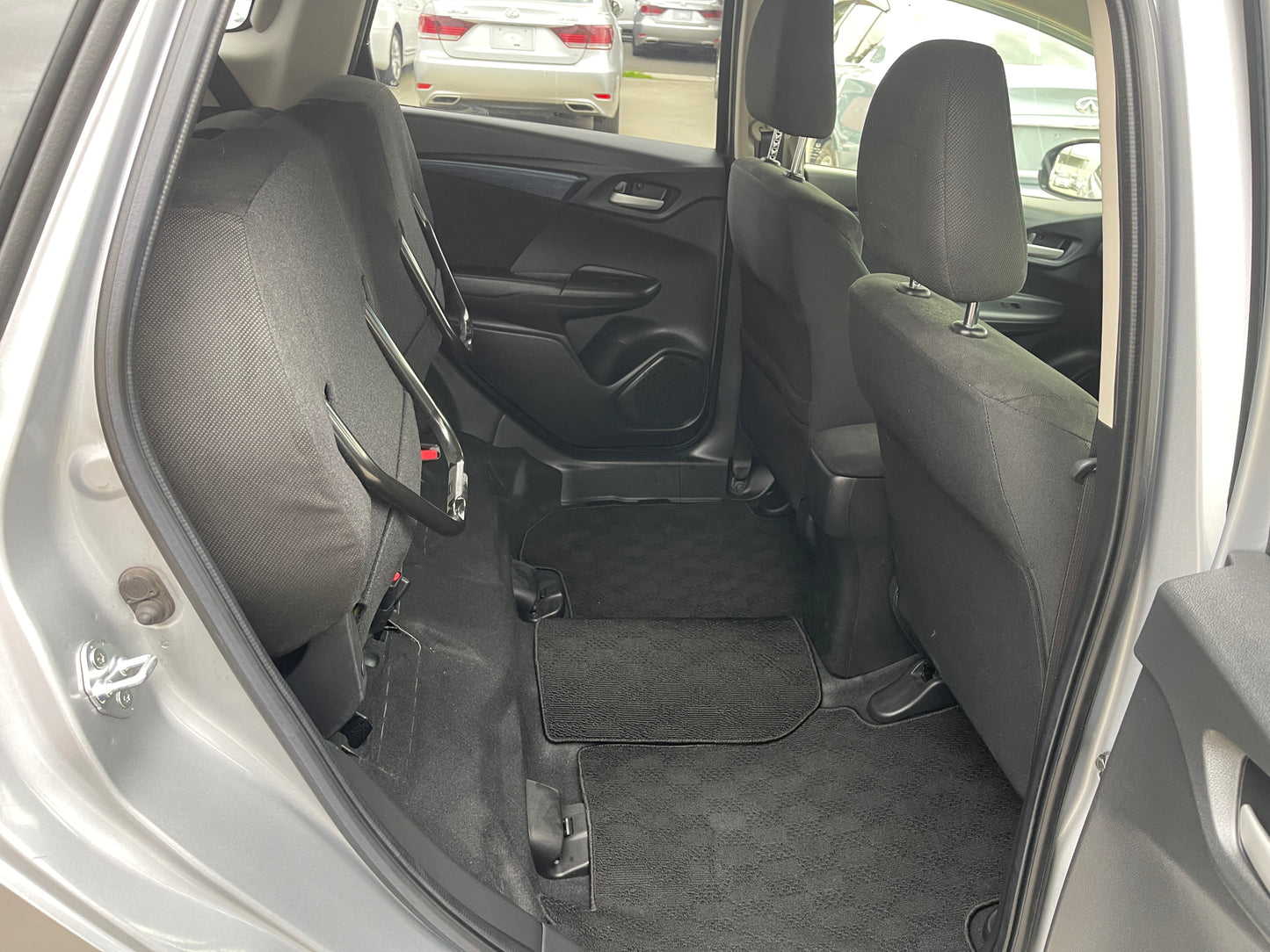 2018 Honda Shuttle 1.5 Hybrid interior view showing spacious back seats and floor mats.