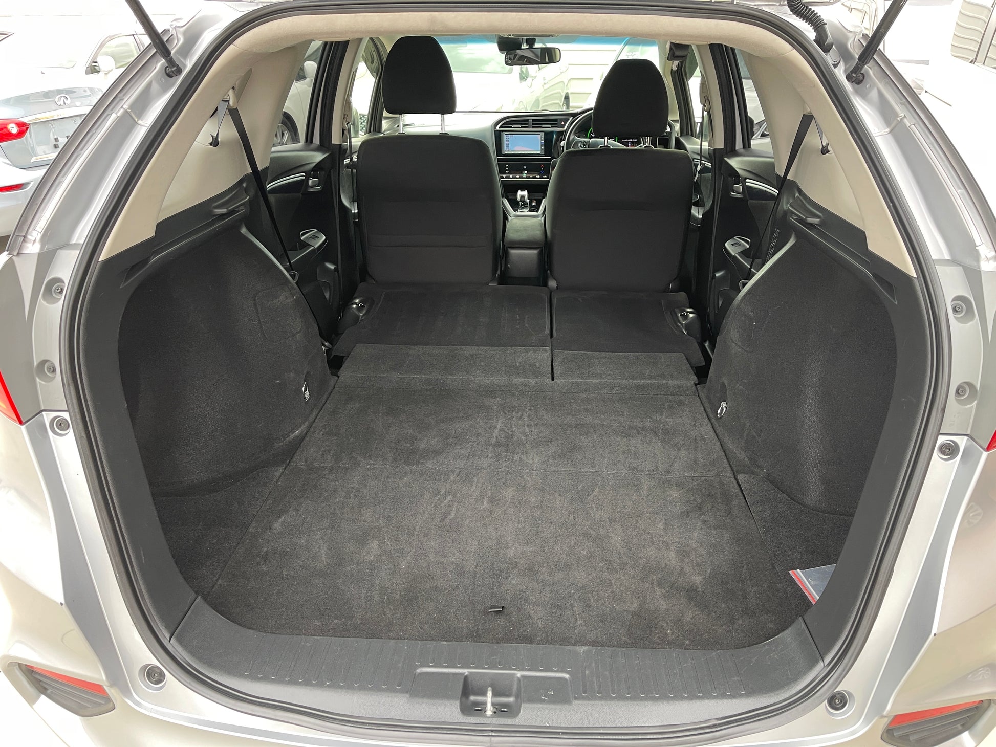 Interior trunk space of 2018 Honda Shuttle 1.5 Hybrid X, showcasing ample storage for luggage and gear.