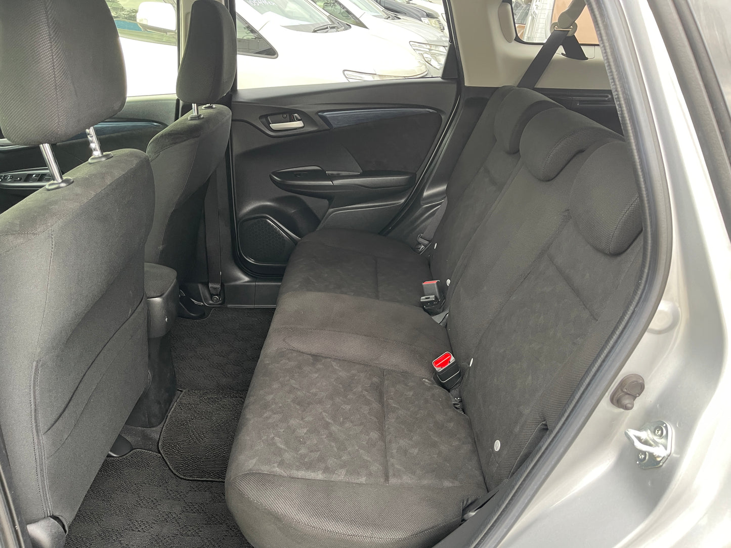 2018 Honda Shuttle 1.5 Hybrid rear seating area showcasing comfortable black upholstery.