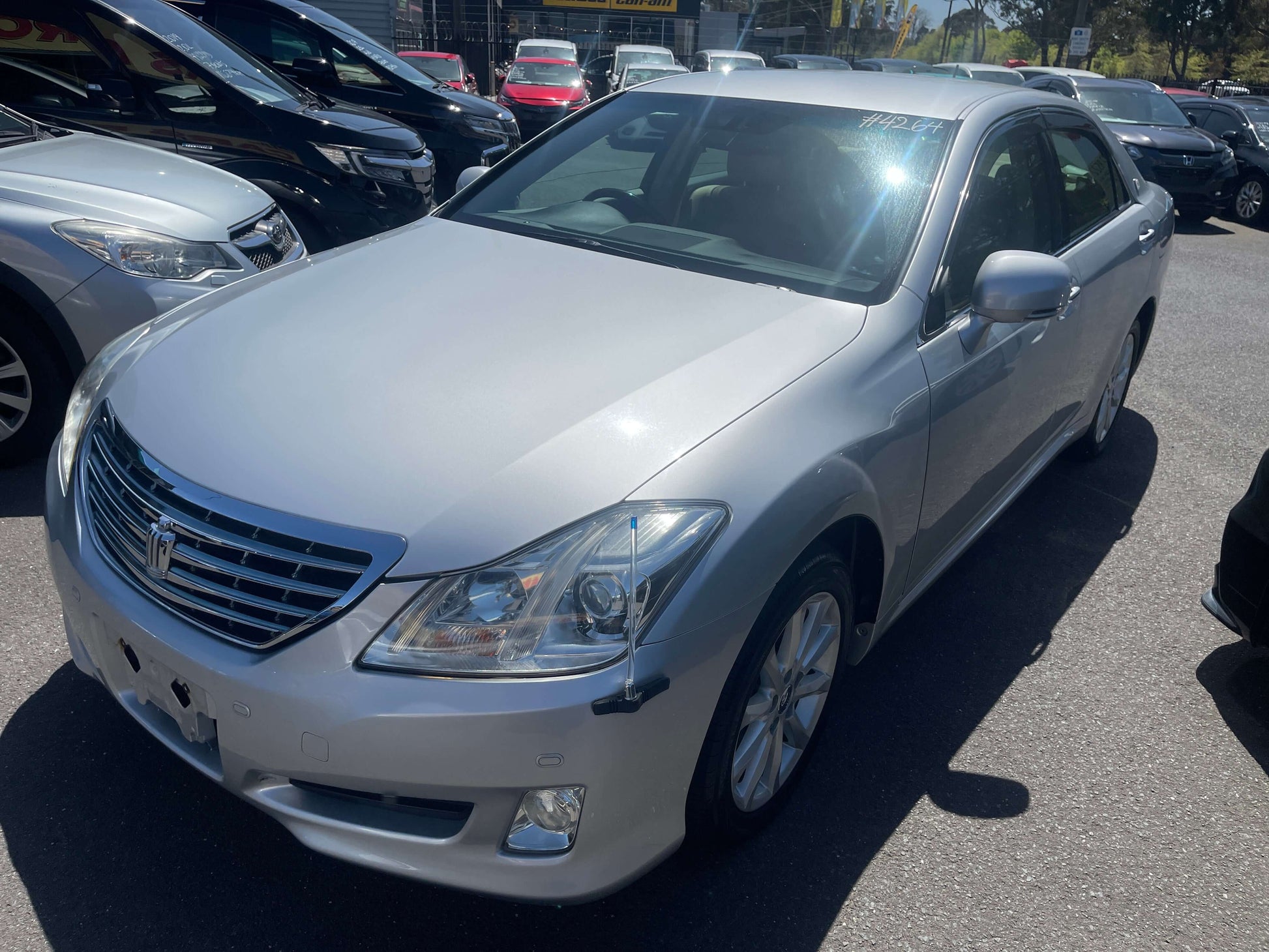 2008 Toyota Crown V6 3.0L Royal Saloon Luxury Sedan in silver parked among other cars.