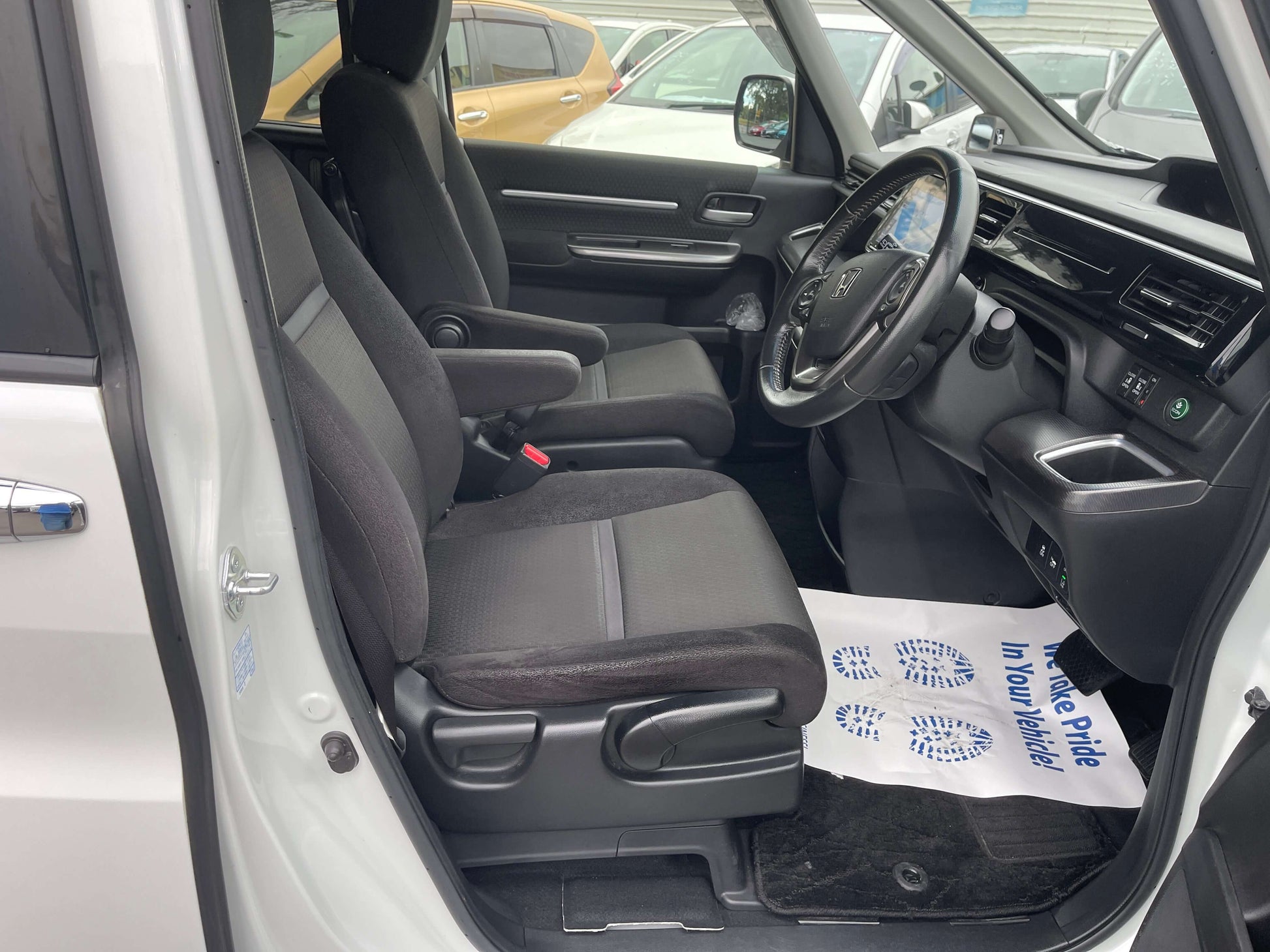 Interior view of a 2018 Honda Honda Stepwgn 2.0 Spada Hybrid with black seats and modern dashboard.